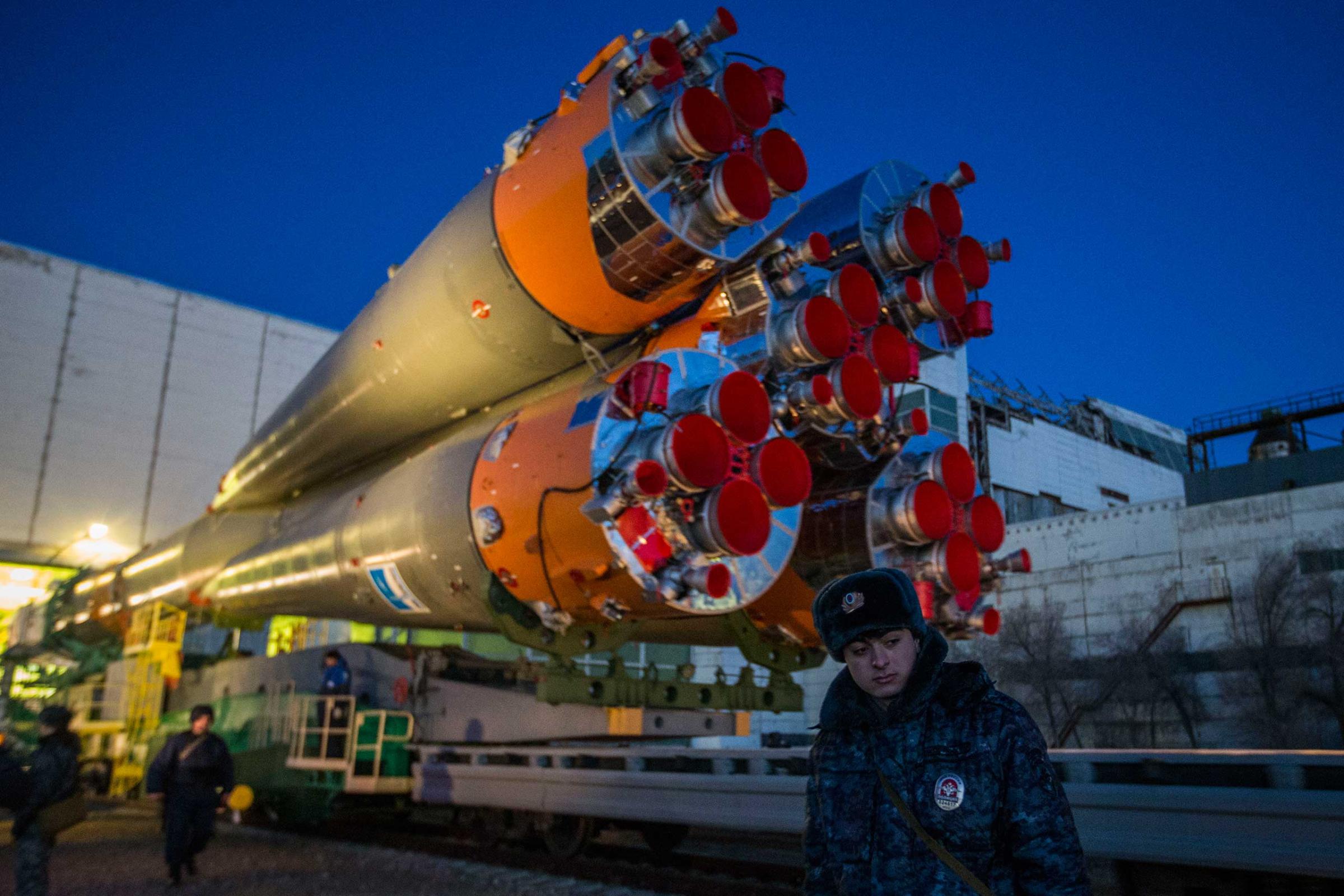 A member of the Russian guard stands in front of the Soyuz as it is rolled out for launch at the Baikonur Cosmodrome in Kazakhstan on Wednesday, March 25.
