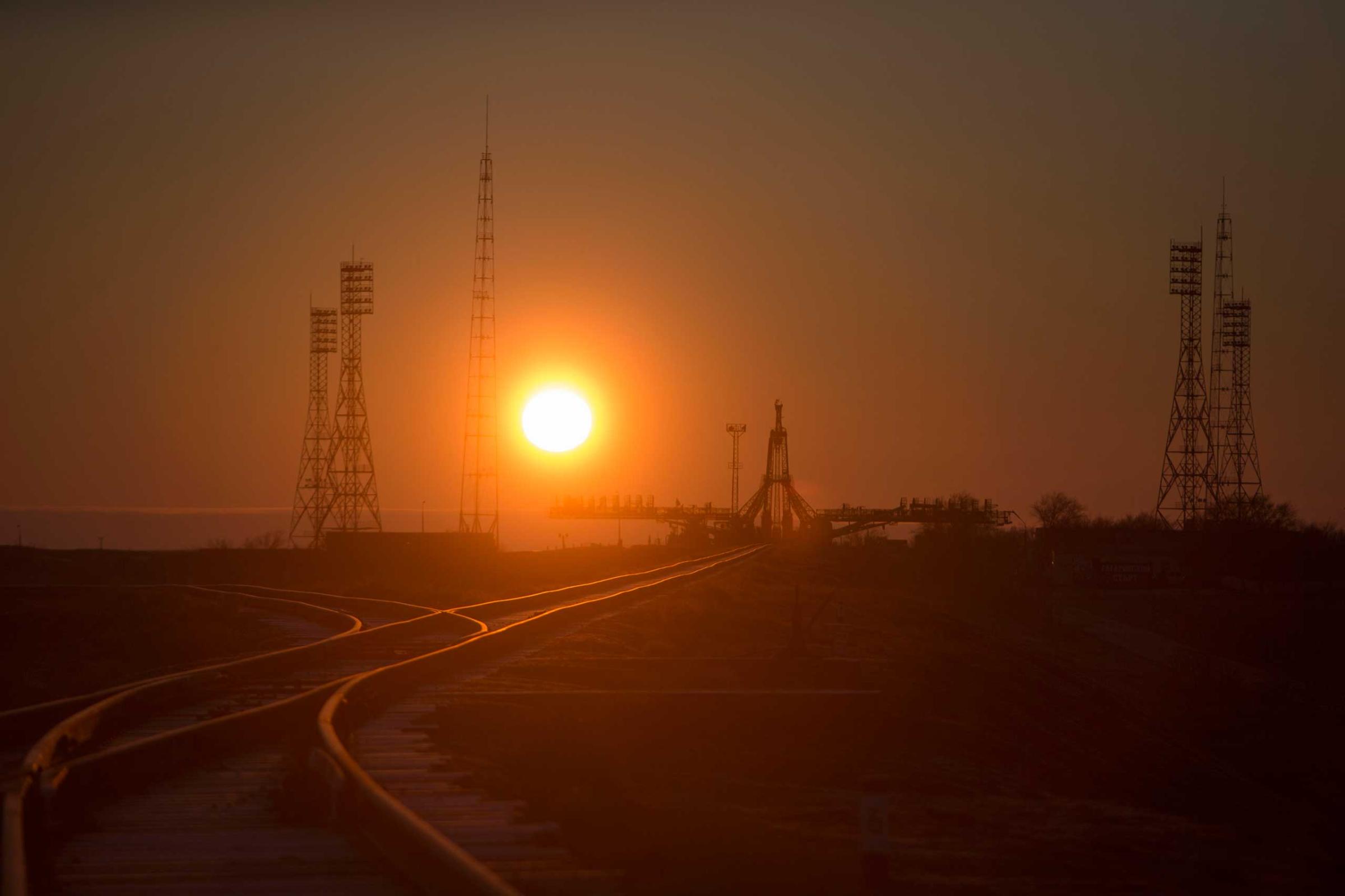 The sunrise silhouettes the structure that helps stabilize and service the Soyuz at the Baikonur Cosmodrome in Kazakhstan on Wednesday, March 25.