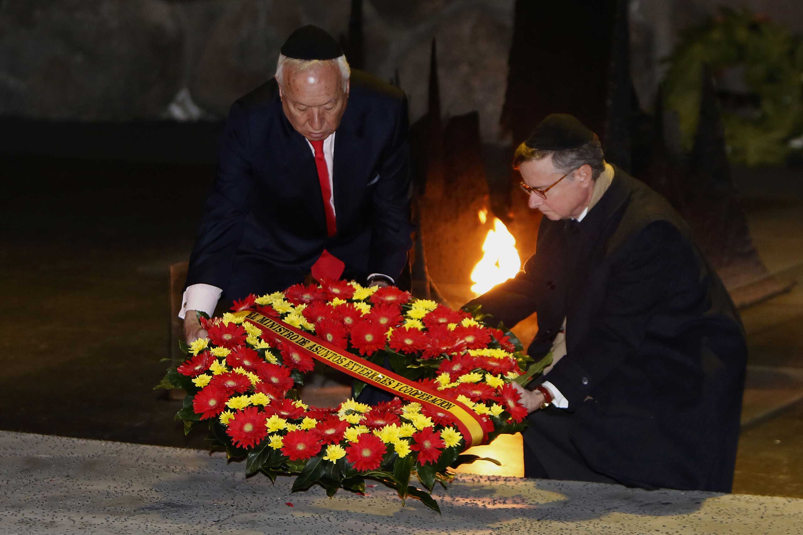 Spanish Foreign Minister Jose Manuel Garcia-Margallo (L) lays a wreath at the Hall of Remembrance on Jan. 14, 2015, during his visit to the Yad Vashem Holocaust Memorial museum in Jerusalem that commemorates the six million Jews killed by the Nazis during World War II. (Gali Tibbon—AFP/Getty Images)