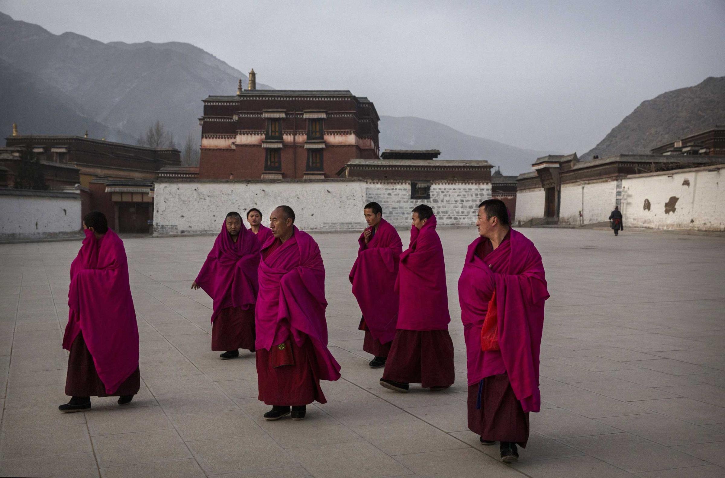 Tibetan Buddhist Monks of the Gelug, or Yellow Hat order, leave morning prayers during Monlam or the Great Prayer rituals on March 3, 2015 at the Labrang Monastery, Xiahe County, Amdo, Tibetan Autonomous Prefecture, Gansu Province, China.