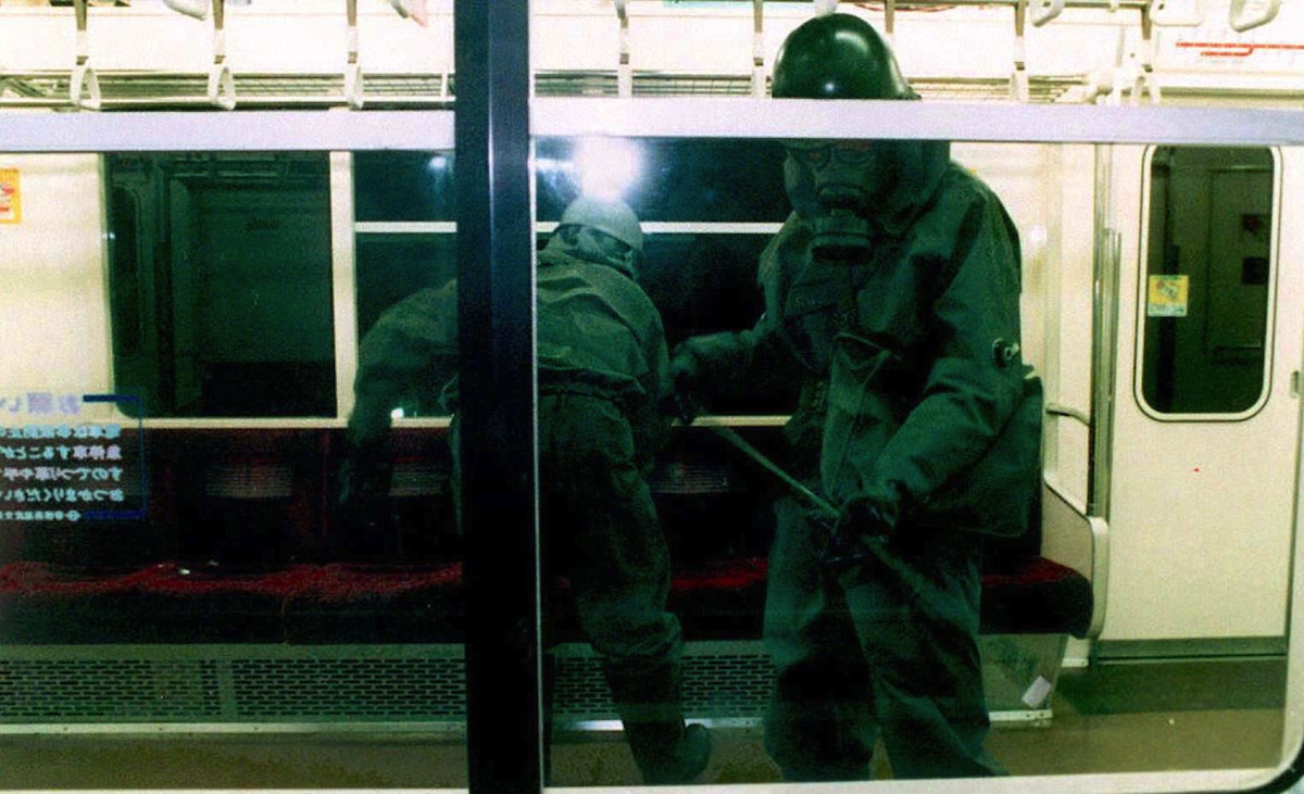 Wearing gas masks, members of the Japanese Ground Self-Defense Forces (JSDF) clean up subway cars late on March 20, 1995 (JIJI PRESS-JSDF—AFP/Getty Images)