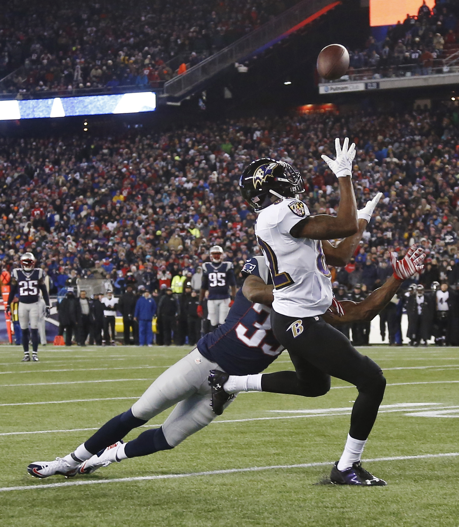 Baltimore Ravens wide receiver Torrey Smith (82) catches a pass in front of New England Patriots cornerback Brandon Browner (39) in the second half of an NFL divisional playoff football game Saturday, Jan. 10, 2015, in Foxborough, Mass.