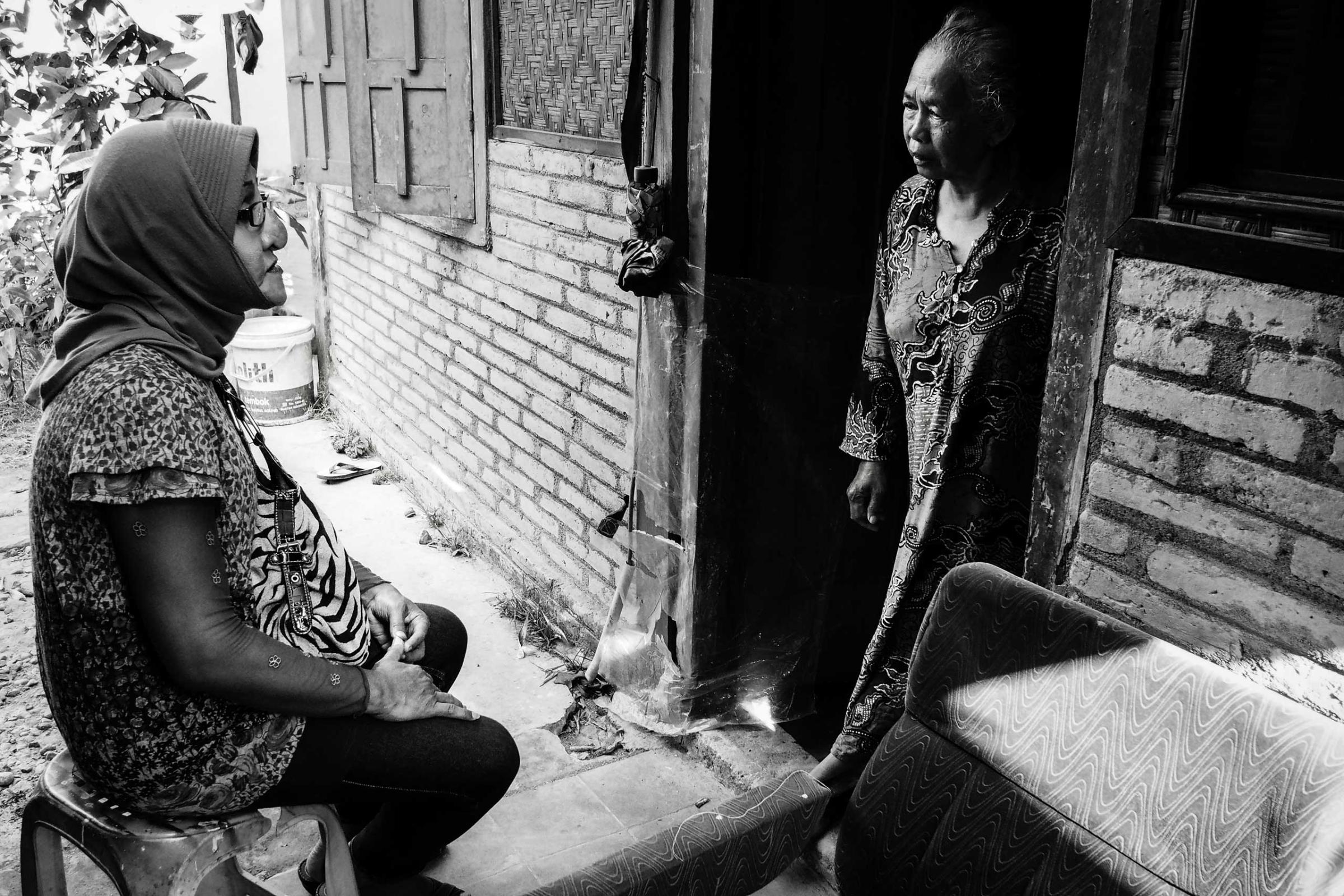 Shinta Ratri talks to her mother on the threshold of her family house where she is not allowed to enter.