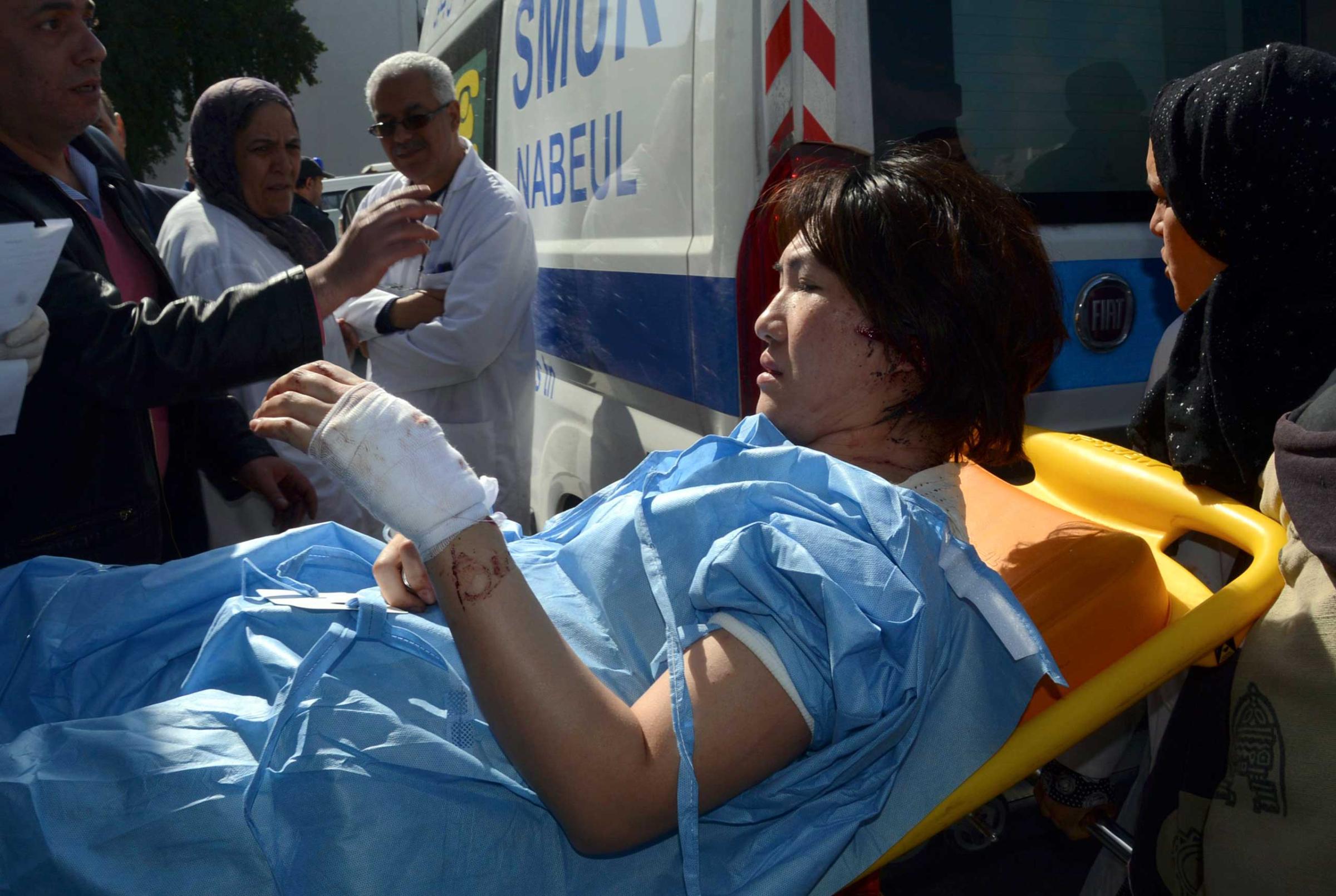 A victim arrives at the Charles Nicoles hospital, Wednesday, March 18, 2015 in Tunis.