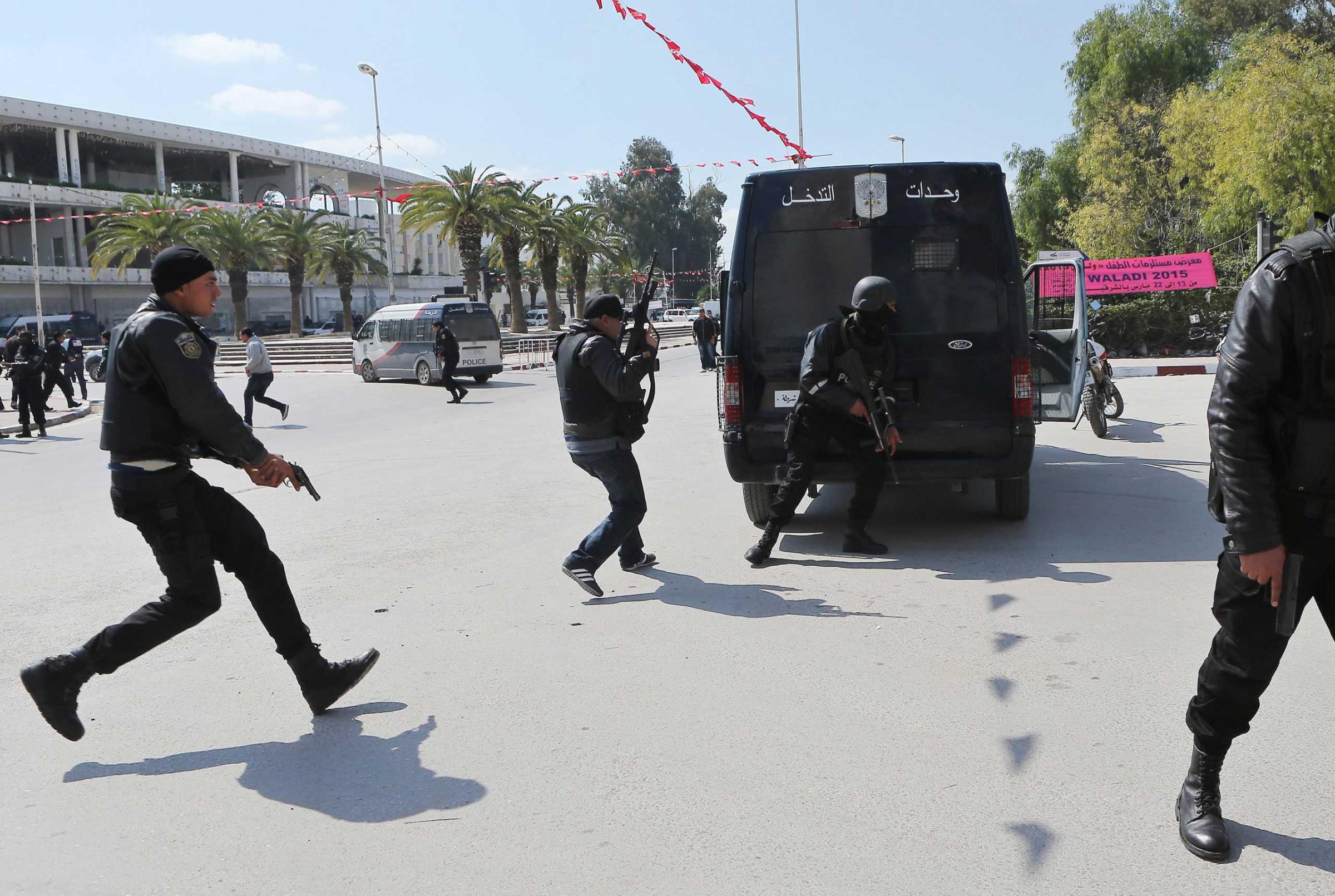 Members of the Tunisian security services take up a position after gunmen reportedly took hostages near the country's parliament, outside the National Bardo Museum, Tunis, March 18, 2015.