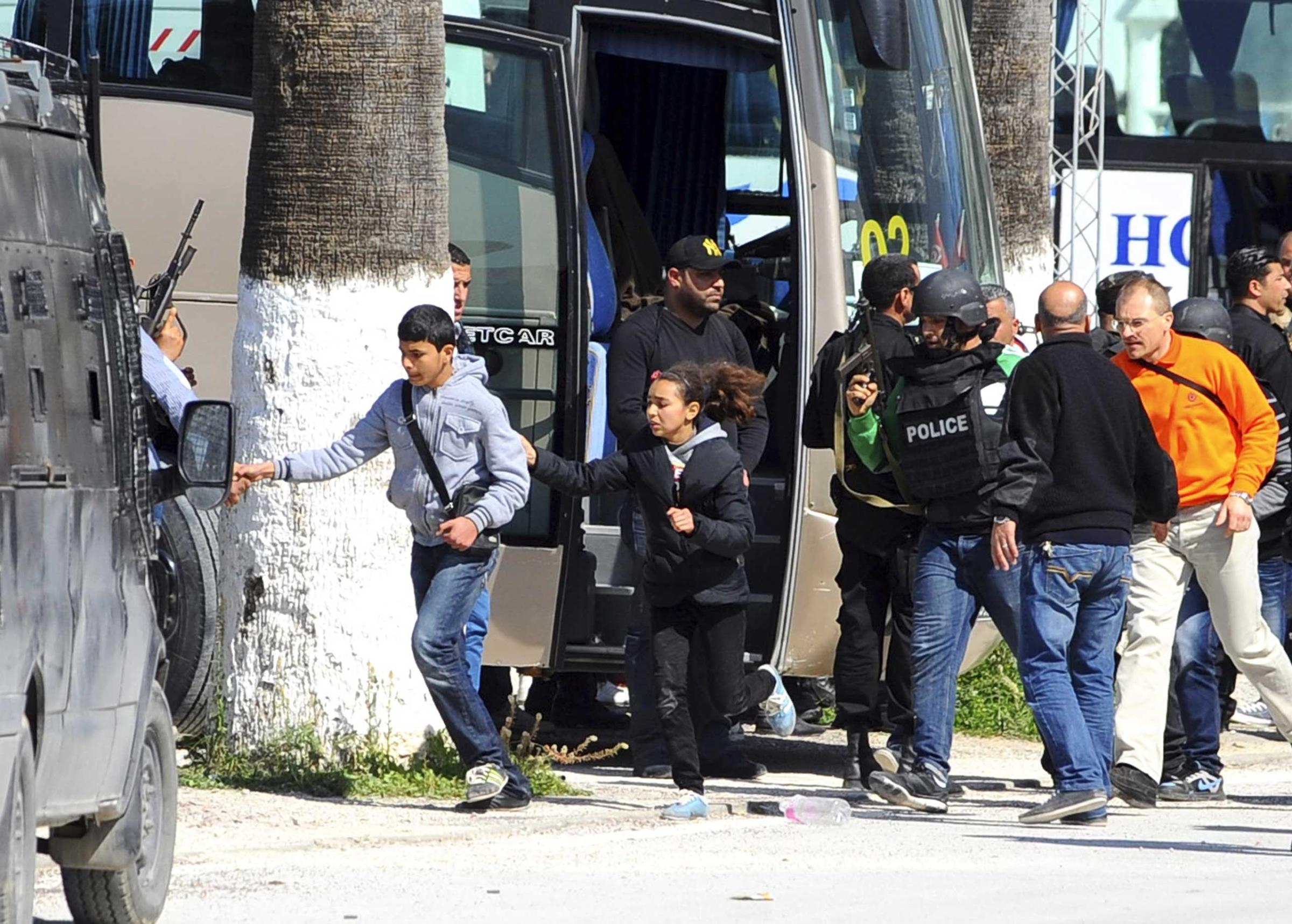Tourists and visitors from the Bardo museum are evacuated in Tunis, March 18, 2015.
