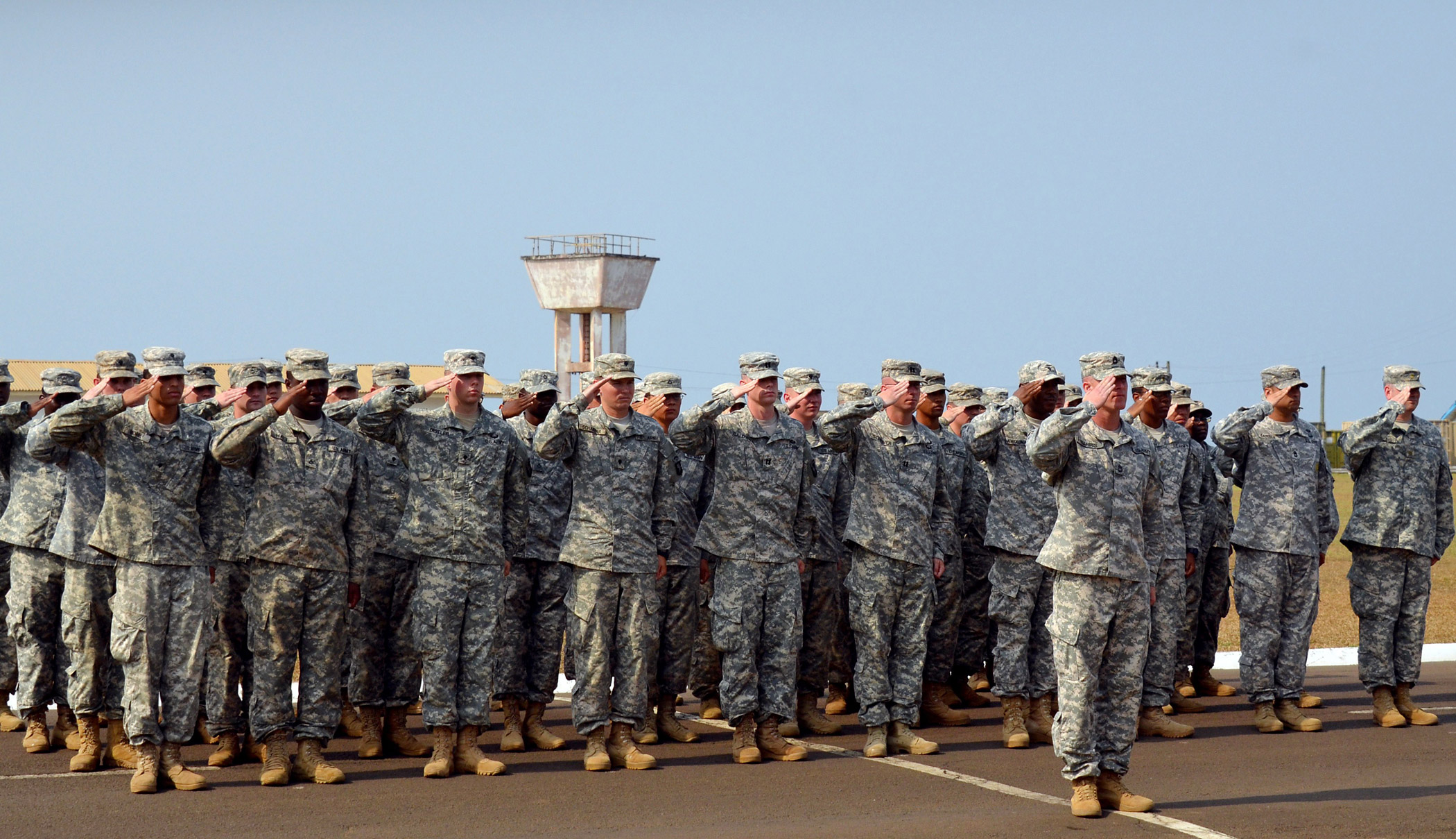 US soldiers of the 101st Airborne Division salute during the ceremonial folding and stowing of the flag at the Barclay Training Camp in Monrovia on Feb. 26, 2015, marking the end of the "Joint Forces Command United Assistance" mission. (Zoom Dosso—AFP/Getty Images)