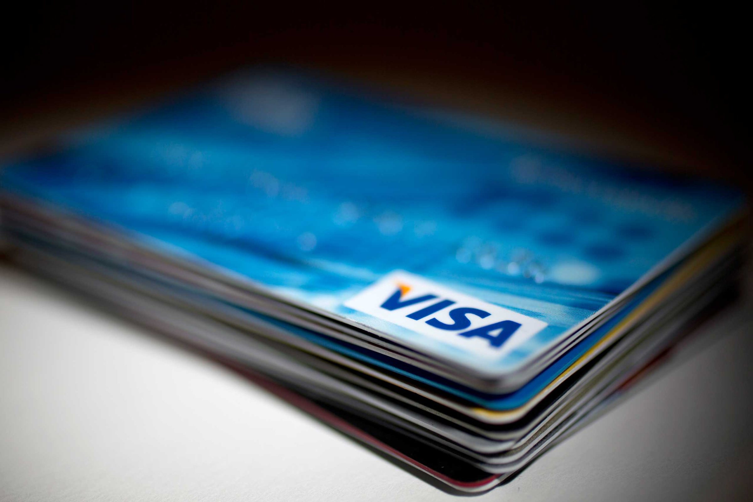A Visa Inc. credit card sits on top of credit and debit cards arranged for a photograph in Washington on Jan. 29, 2014.