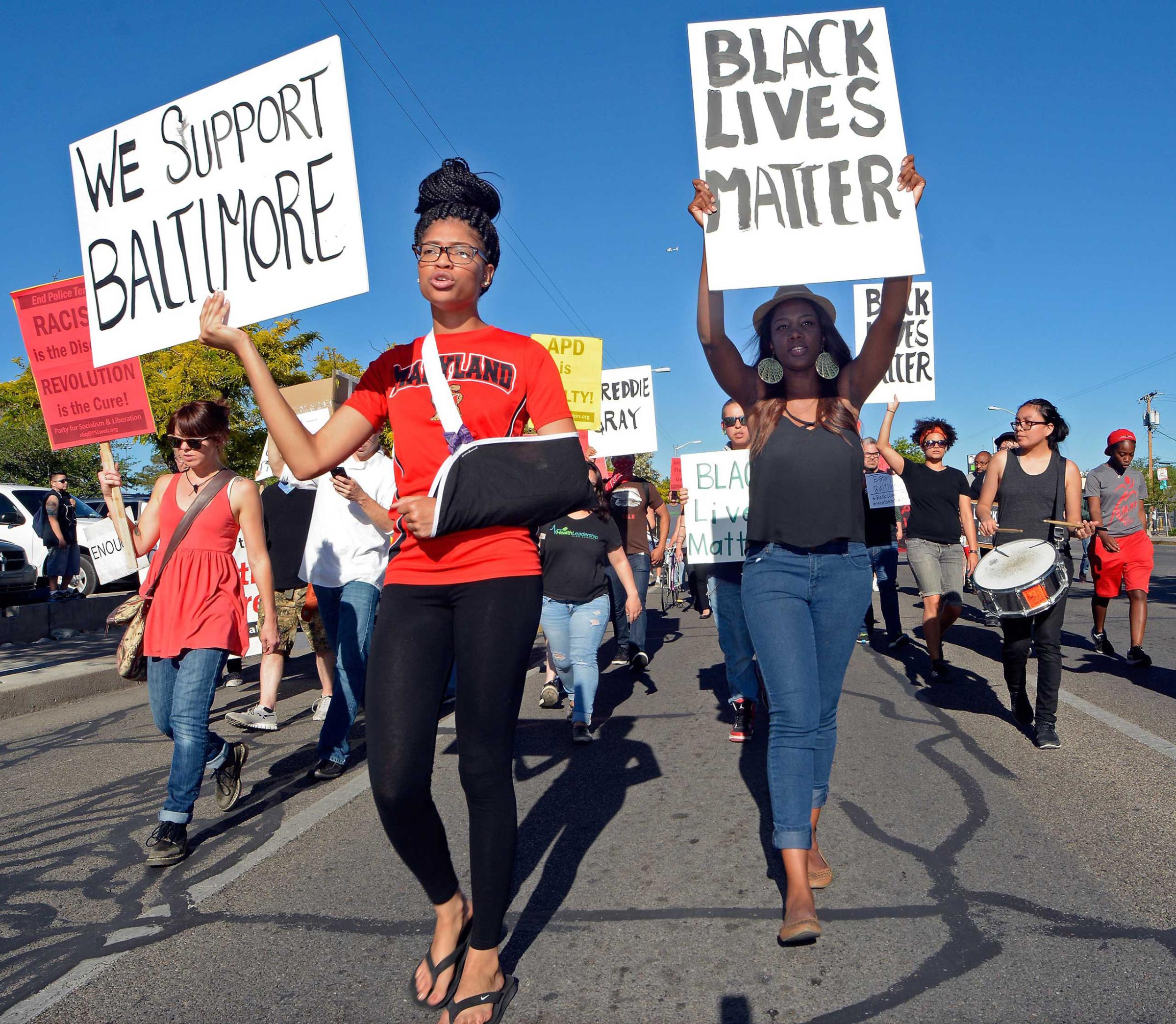 Cinnamon Burton and Skye Johnson join protesters, in solidarity with Baltimore, marching in front of the University of New Mexico in Albuquerque, N.M. on April 29, 2015.