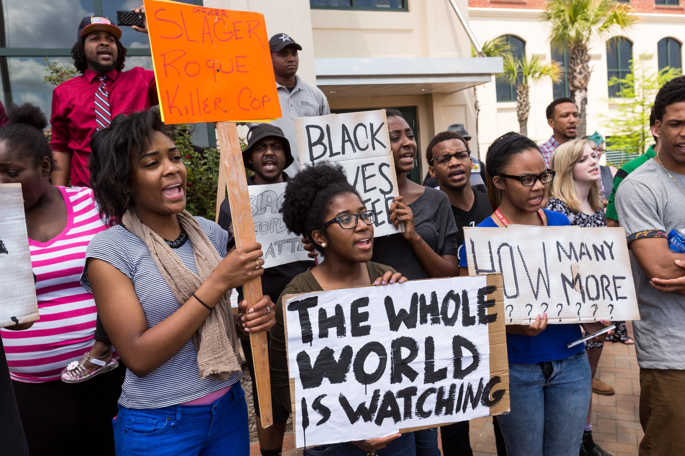 People participate in a rally to protest the death of Walter Scott, who was killed by police in a shooting, outside City Hall in North Charleston, S.C. on April 8, 2015.
