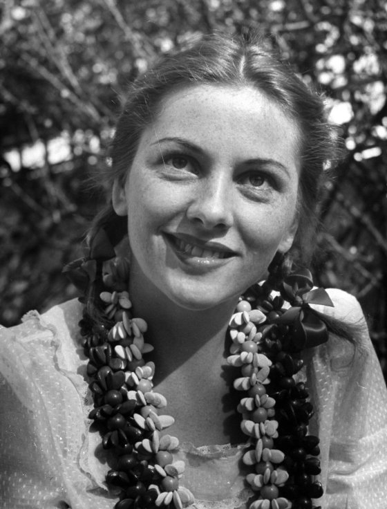 Joan Fontaine in natural freckles and pigtails looks very different but no less pretty and fragile than she does in her film make-up and pompadour.