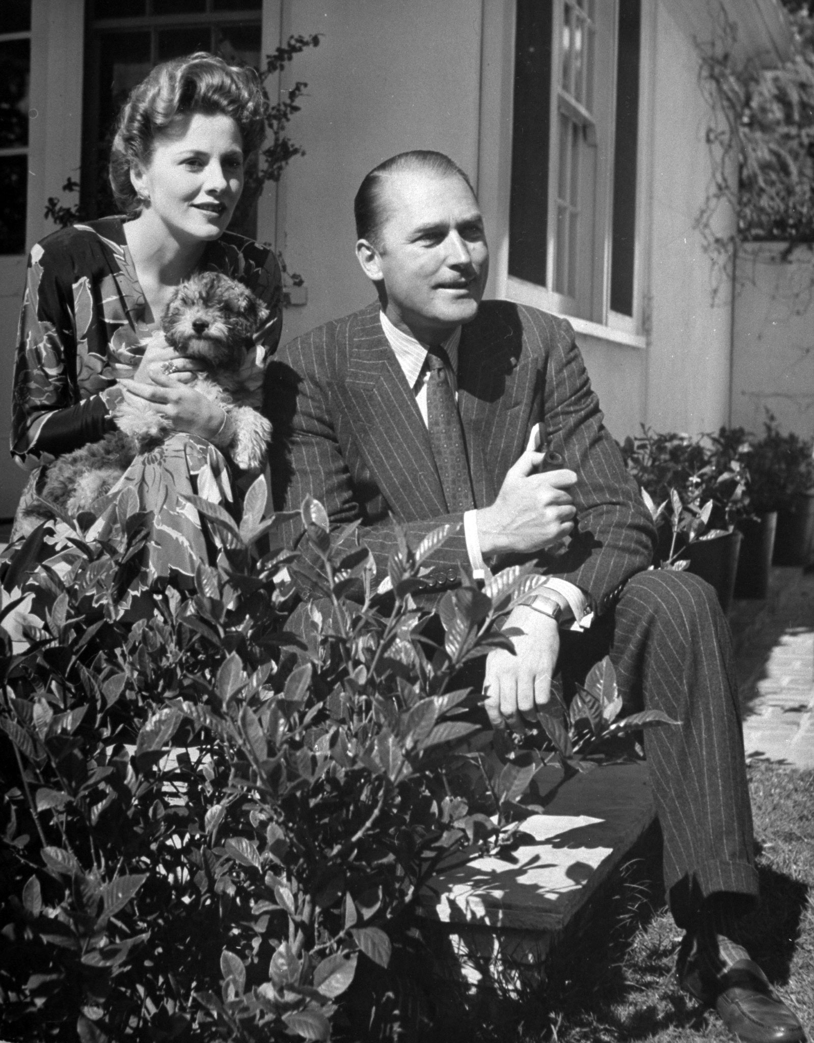 Joan Fontaine with her husband Brian Aherne and her dog, 1942.