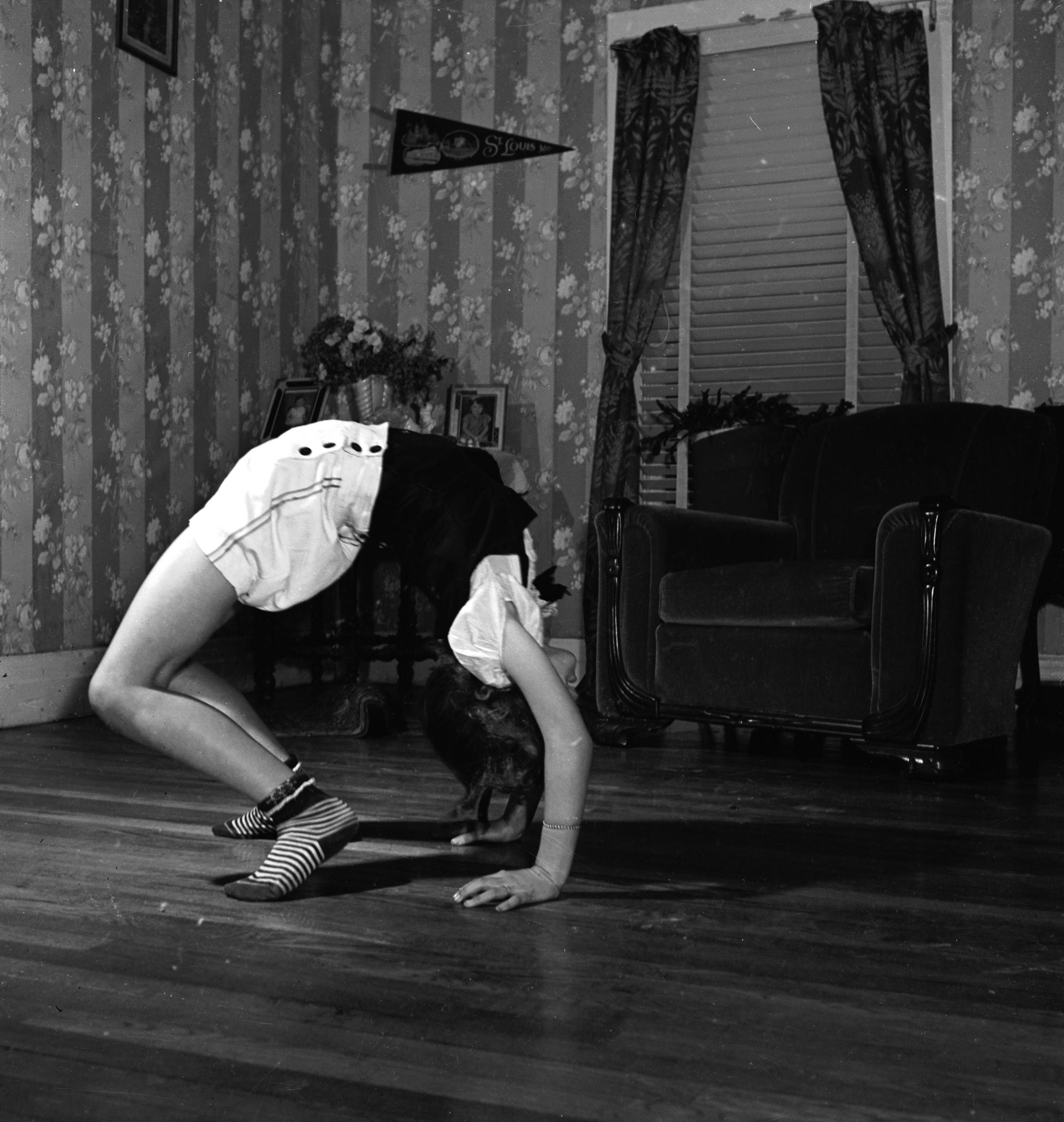 June Carter performing a back bend in the living room of her family's home.