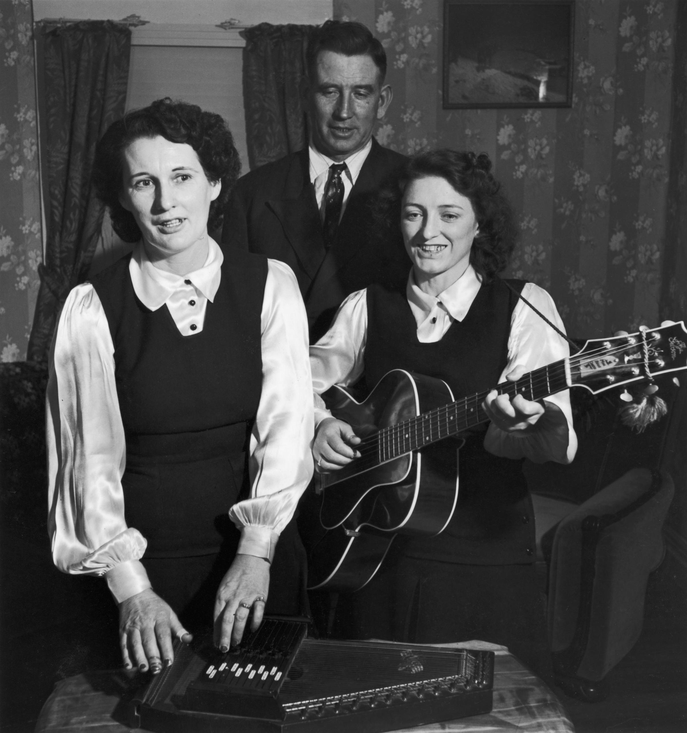 A. P. Carter singing w. wife Sara while she plays autoharp and sings with her sister Maybelle.