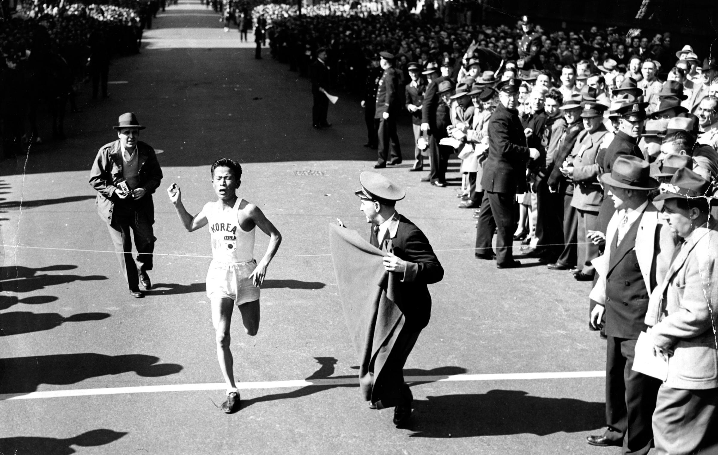 Suh Yun-bok, 24, of South Korea, crosses the finish line, setting a new record in the Boston Marathon, 1947.