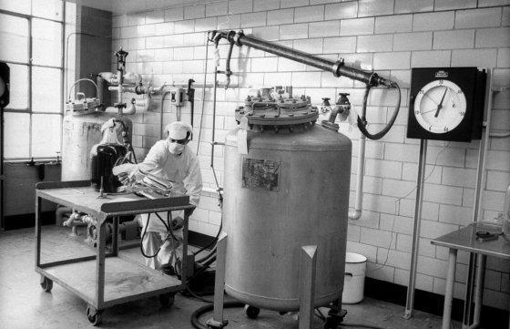 To kill virus, worker makes up formaldehyde solution which is pumped into tube overhead simultaneously with vaccine-to-be from tank. When throughly mixed, liquid goes back into tank where formaldehyde does its work.