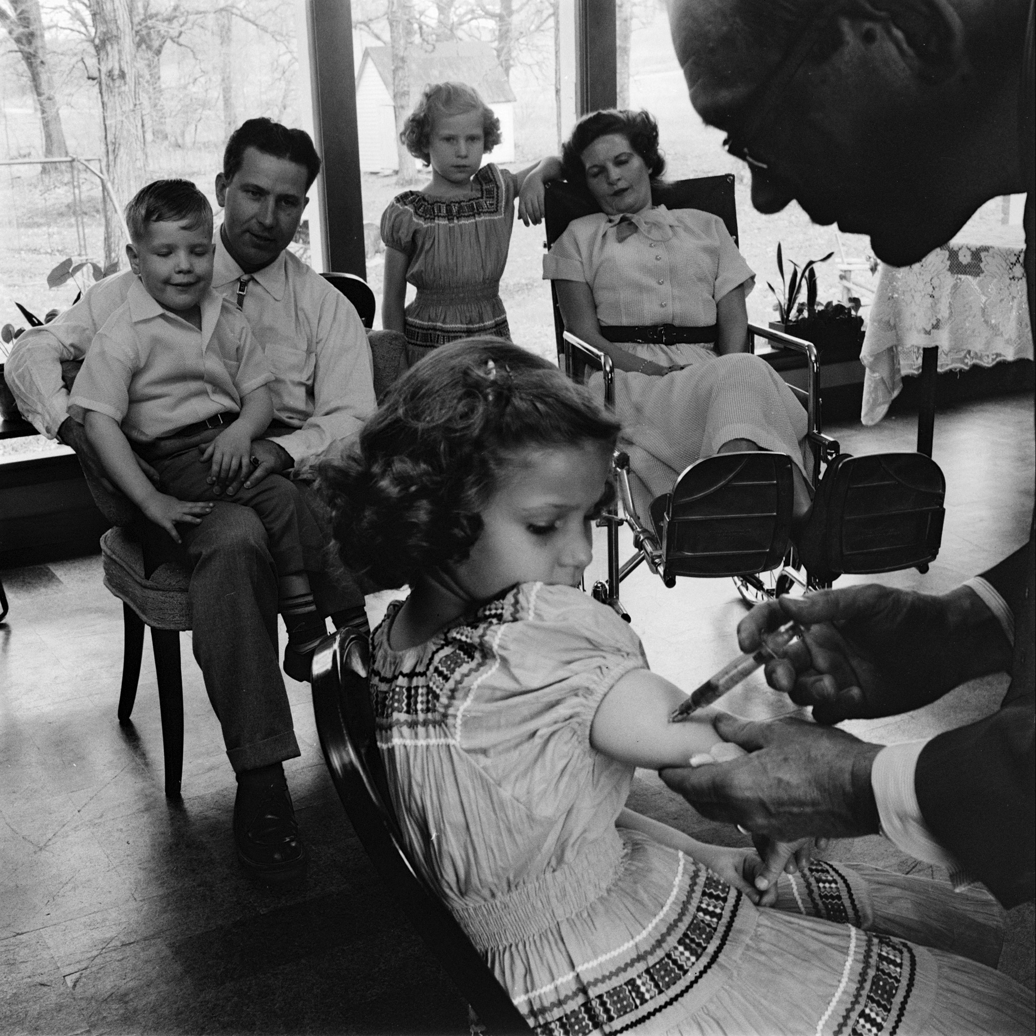 Child receiving a polio vaccination, 1955.