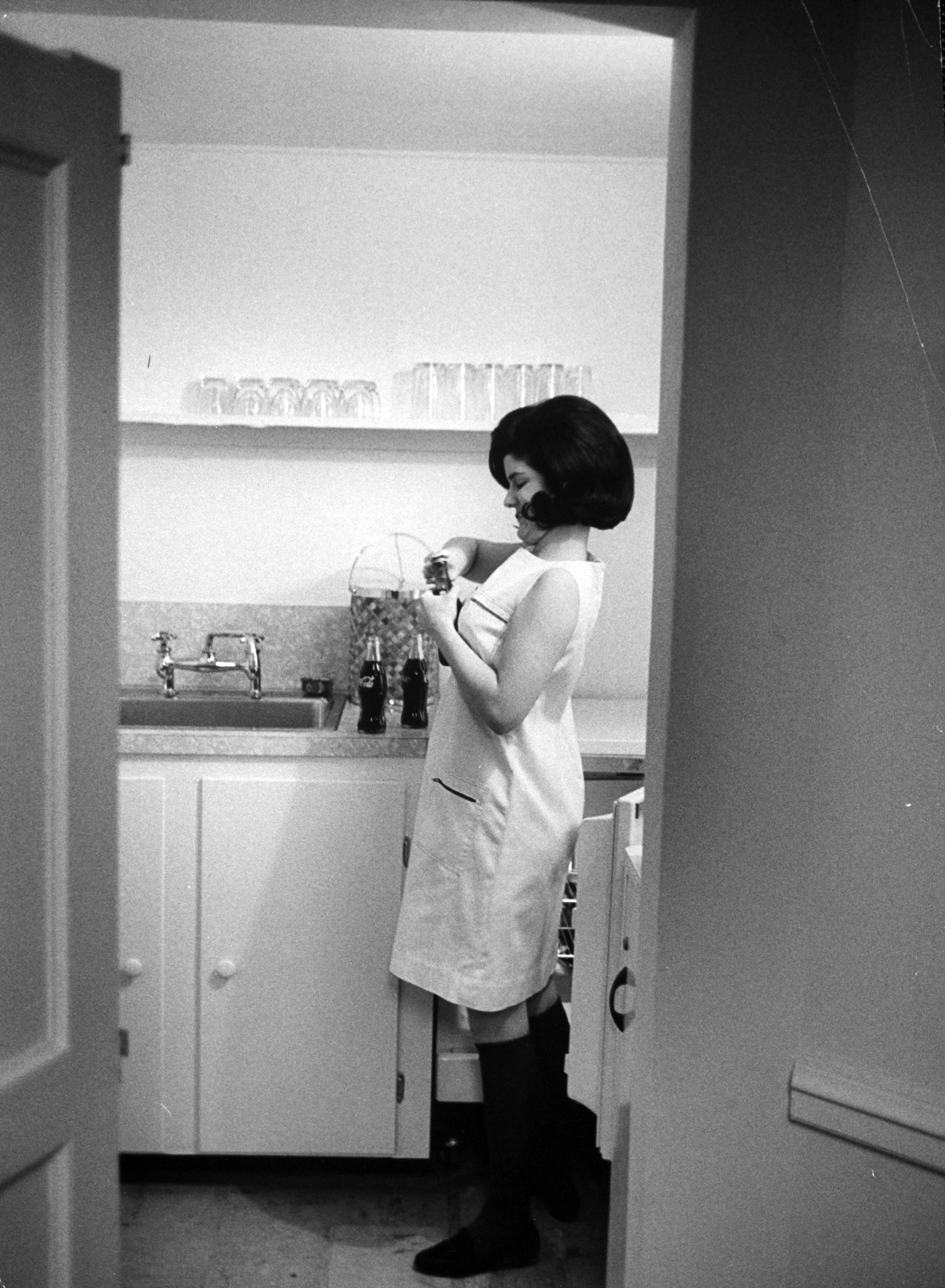 In special kitchenette off the solarium Luci opens drinks for friends. Her allowance of $5 a week covers long-distance calls, Saturday lunches with friends, incidental school supplies.