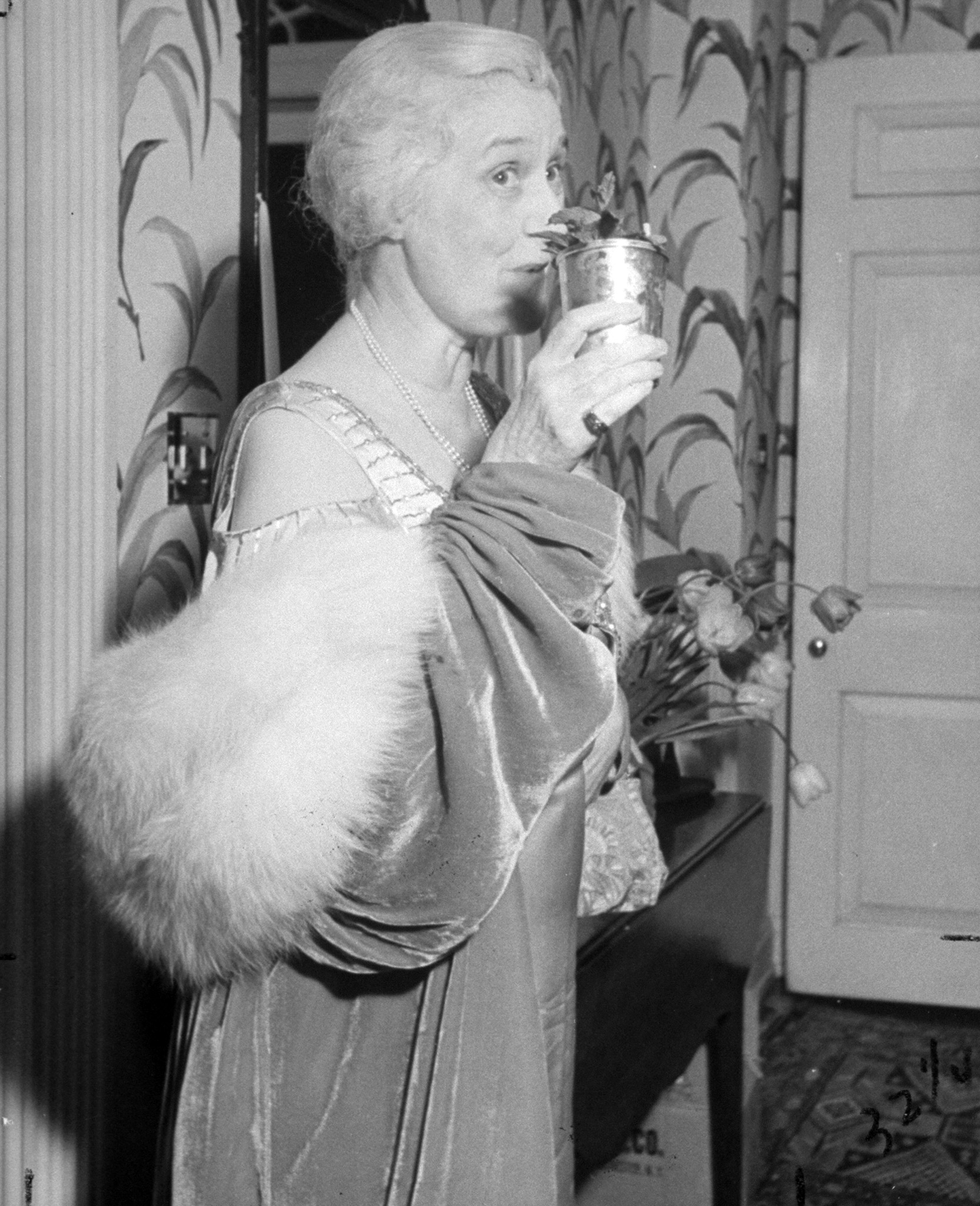 Mint julep drinker Mrs. Eugene Walker demonstrates how a Louisville belle manages to achieve maturity gracefully and happily.