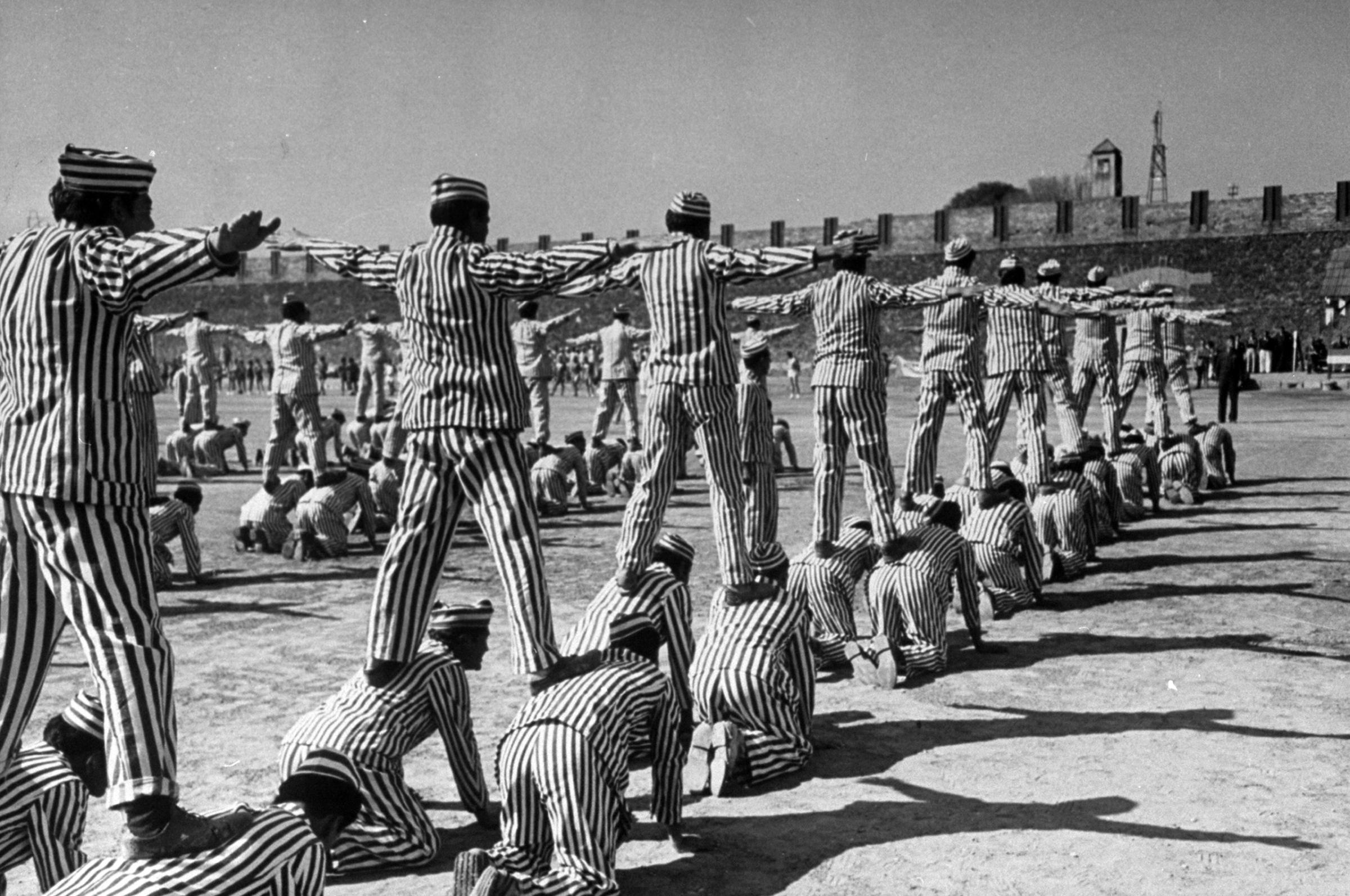 Mass calisthenics use up 4 1/2 hours in the daily routine of most male prisoners. On this same big field they also play softball, volleyball and basketball.