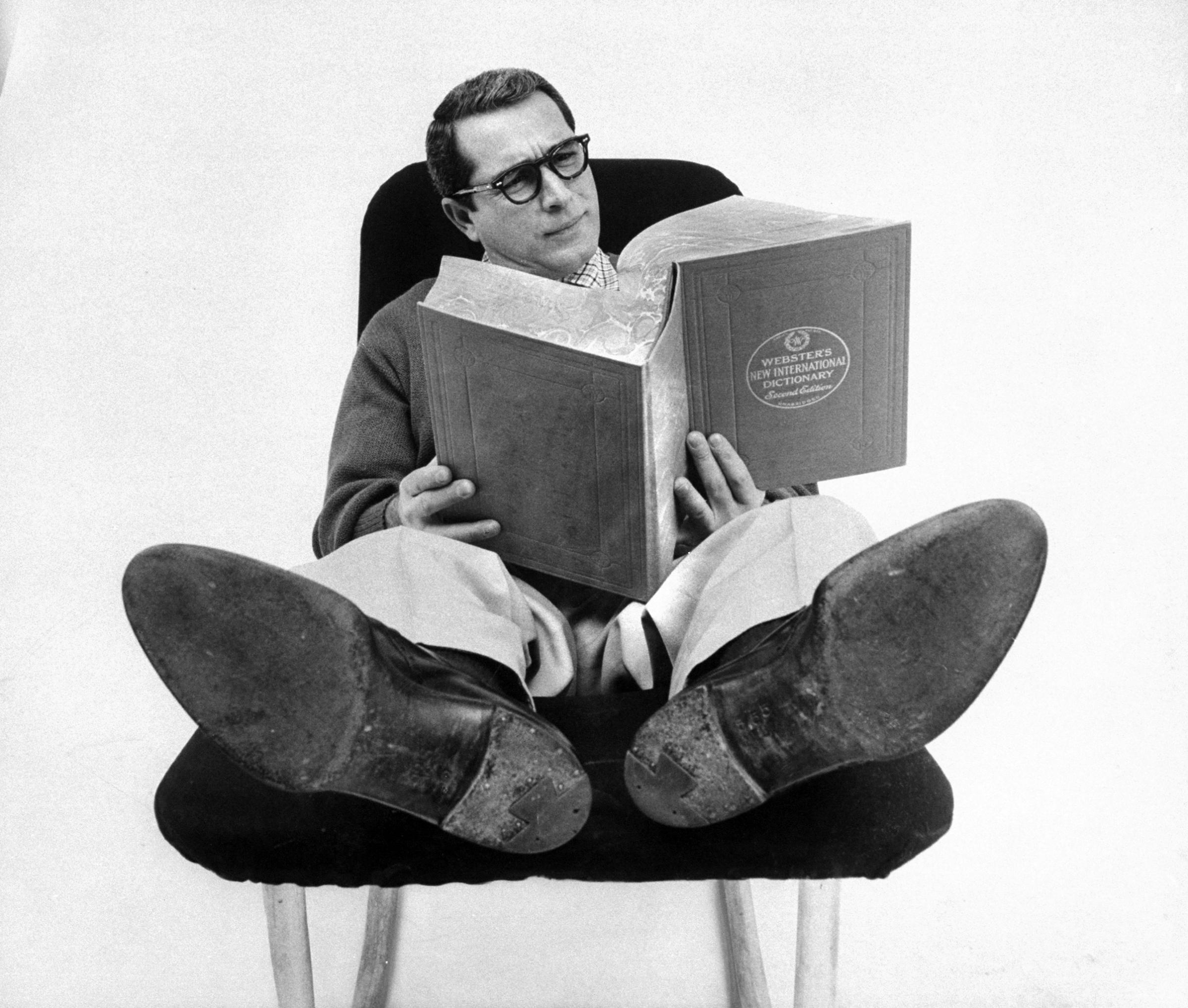 He must be well read. Wearing his glasses and stretched out with a weighty book, he fulfills one requirement of the perfect husband, who must read. A husband should also have a good education, be intelligent but always willing to put his book down and jump to carry groceries.