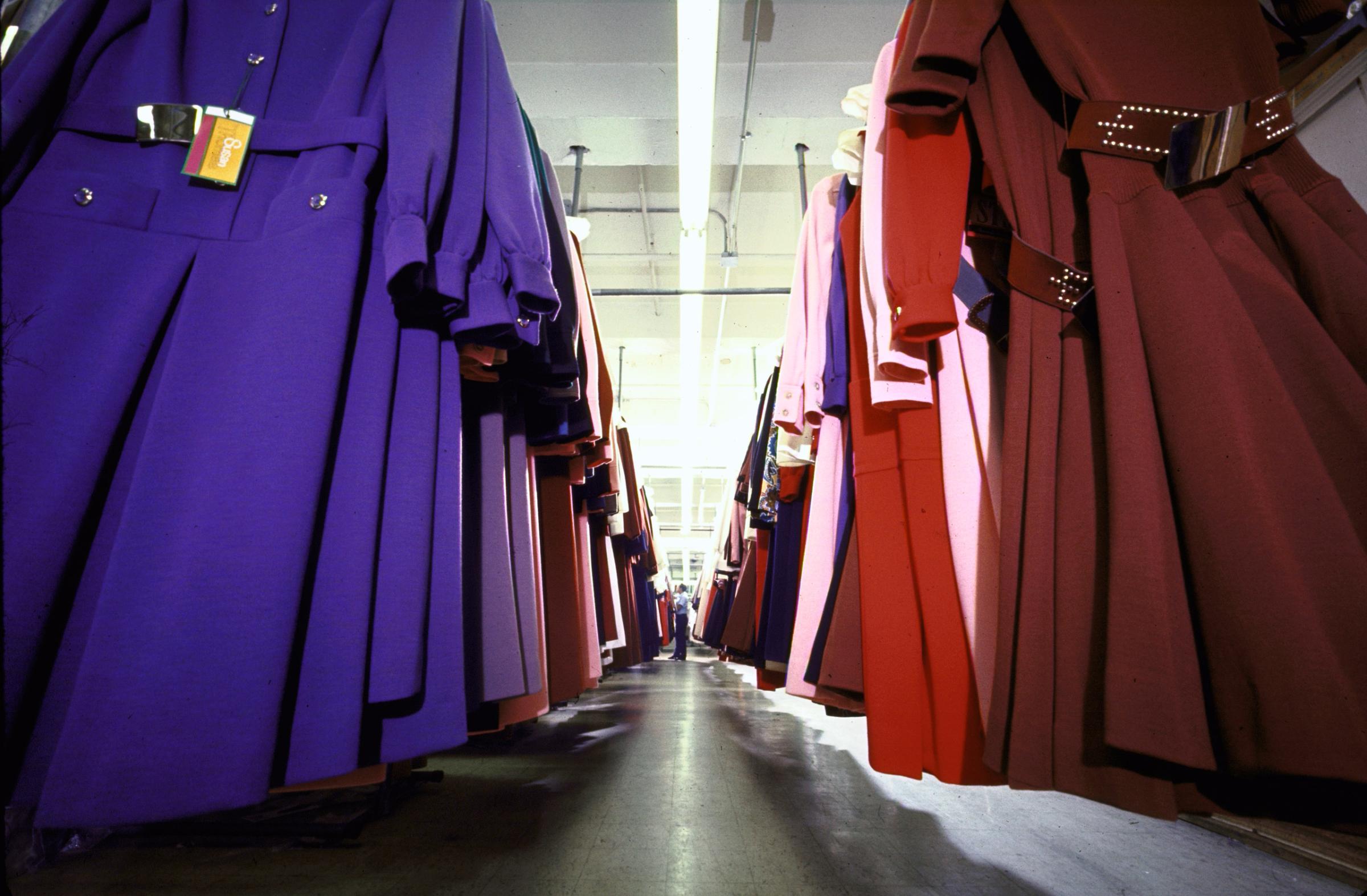 In the garment district warehouse of big time midi-backer Susan Thomas, one thousand medium-priced dresses hang on racks for store delivery.
