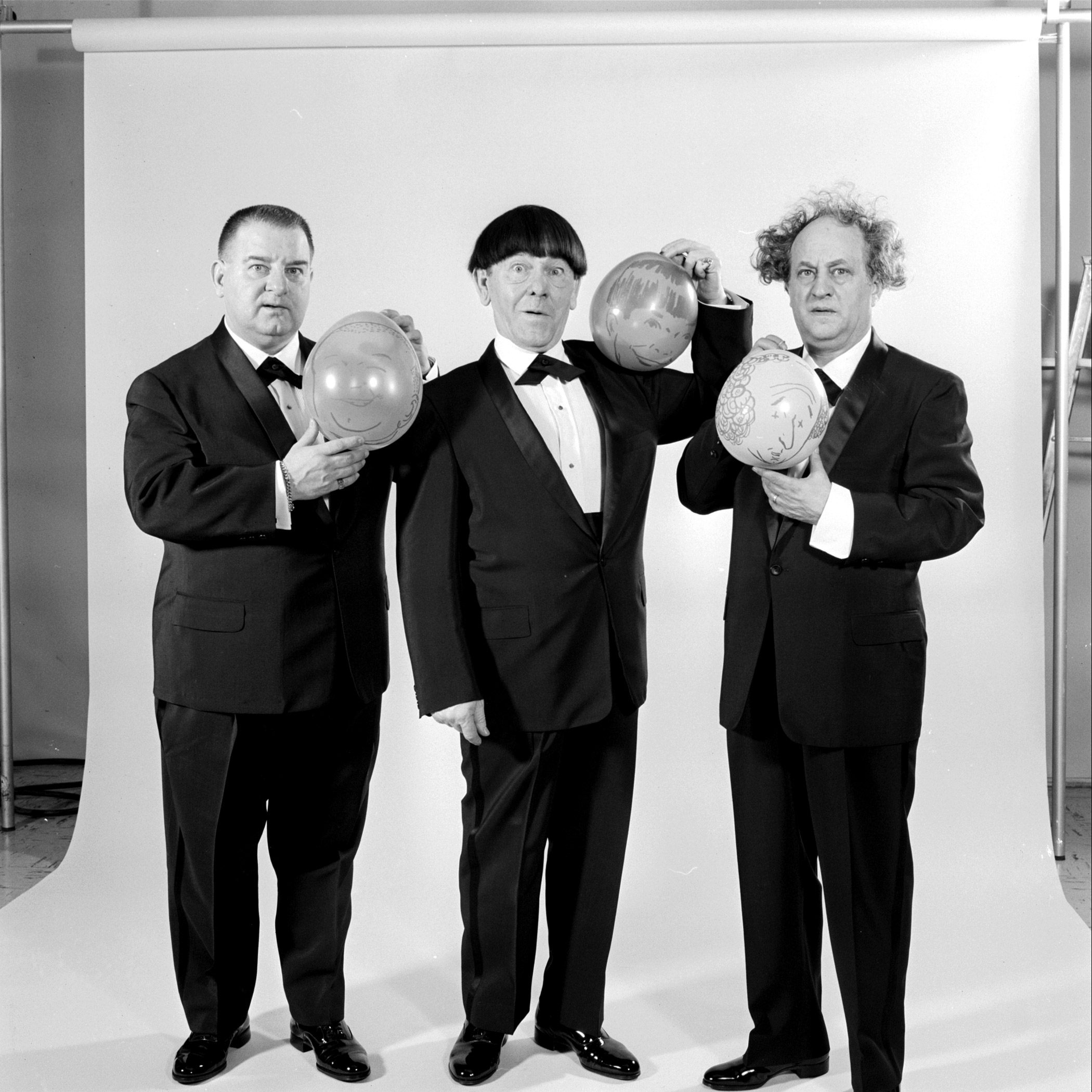 Three Stooges holding balloons in May 1959.