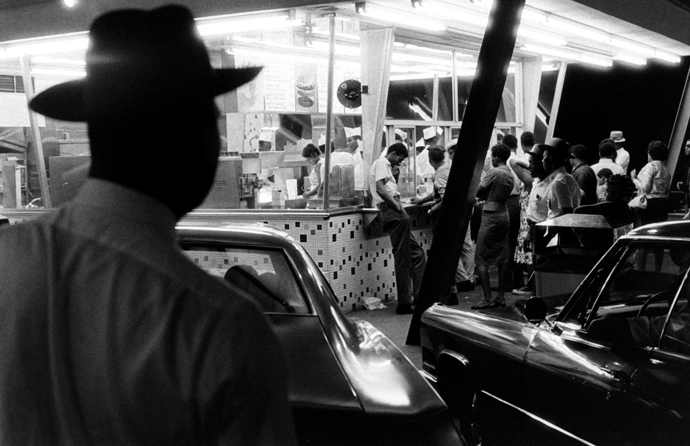 At a drive-in restaurant plagued by brawling, three "rent-a-cops" —looking more authoritative in wide brimmed hats than city police—stand guard on weekends.