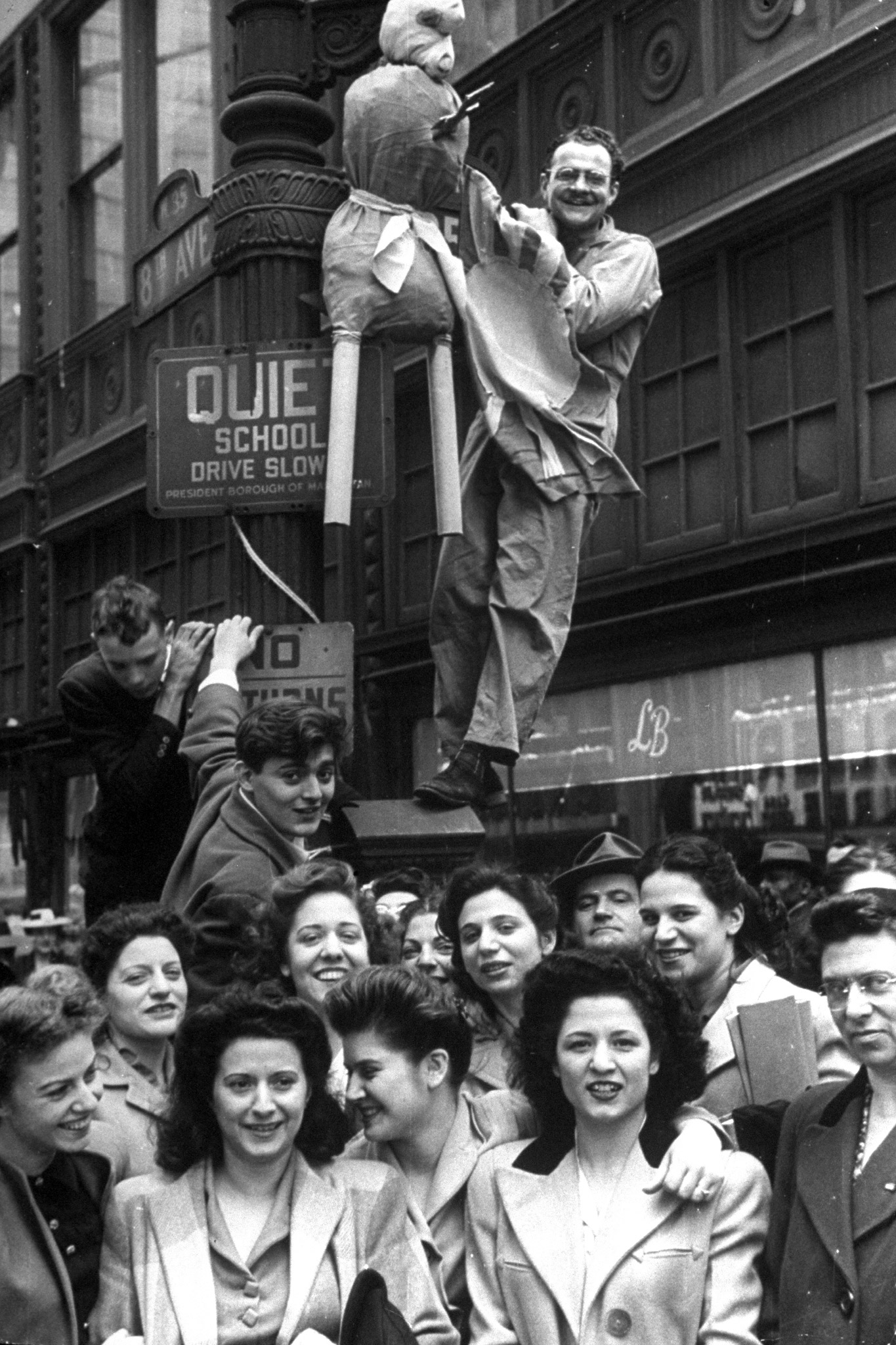A Hitler dummy, with dagger in its heart and a Japanese flag on its chest, is exhibited on Eighth Avenue lamppost.