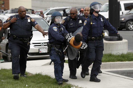 Baltimore Police officers arrest a man following the funeral of Freddie Gray near Mowdamin Mall in Baltimore on April 27, 2015.