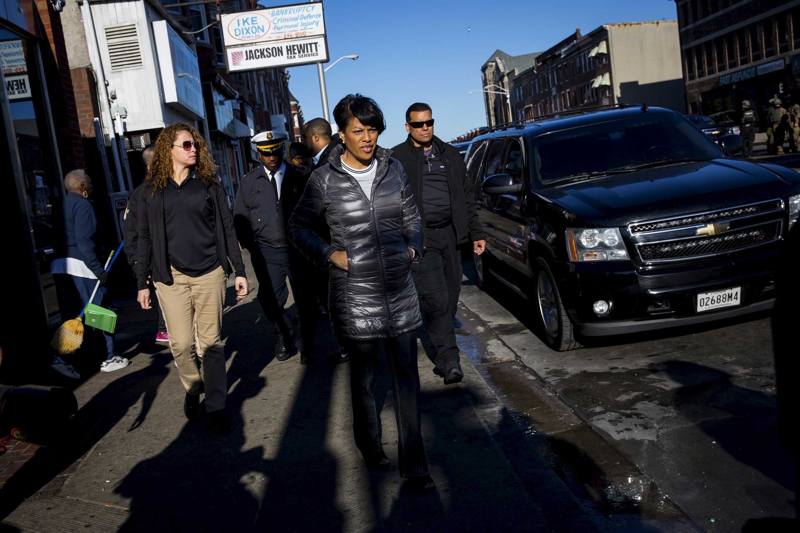 Baltimore mayor Stephanie Rawlings-Blake tours Pennsylvania avenue as Maryland State Police stand guard in Baltimore on April 28, 2015.