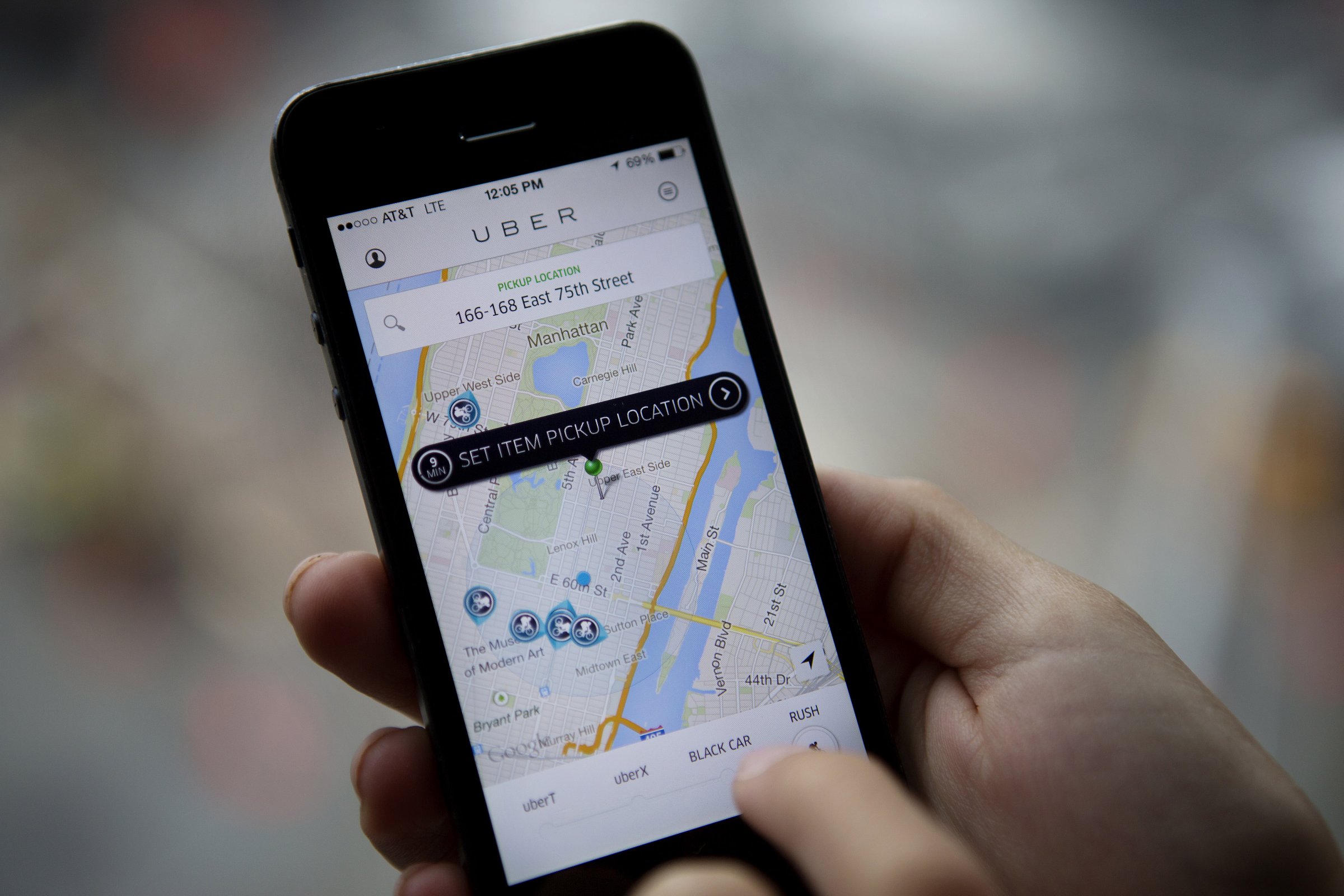 Uber Technologies Inc. car service application (app) is demonstrated for a photograph on an Apple Inc. iPhone in New York, U.S., on, Aug. 6, 2014