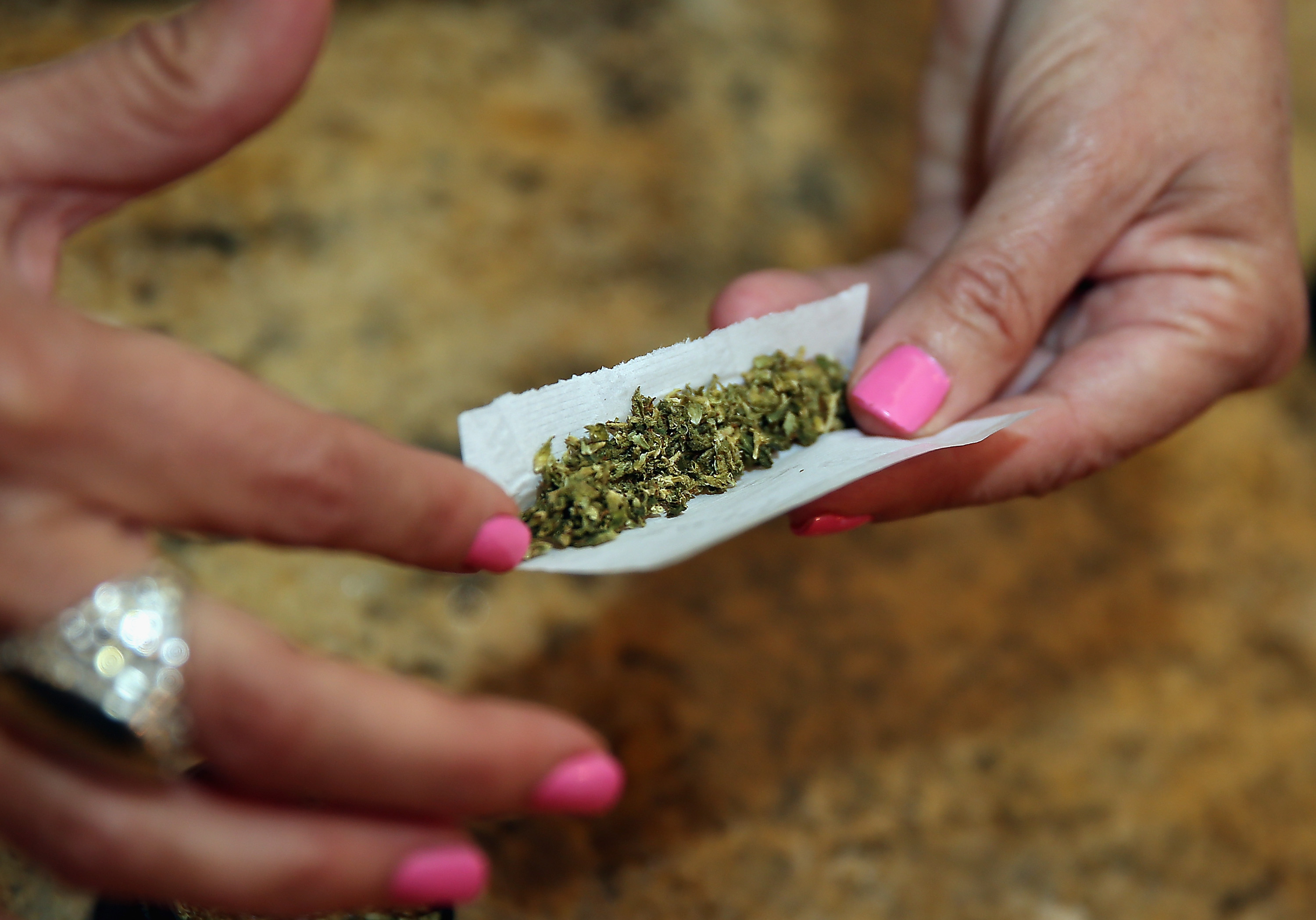 A woman rolls a marijuana cigarette as photographed on August 30, 2014 in Bethpage, New York. (Bruce Bennett&mdash;Getty Images)