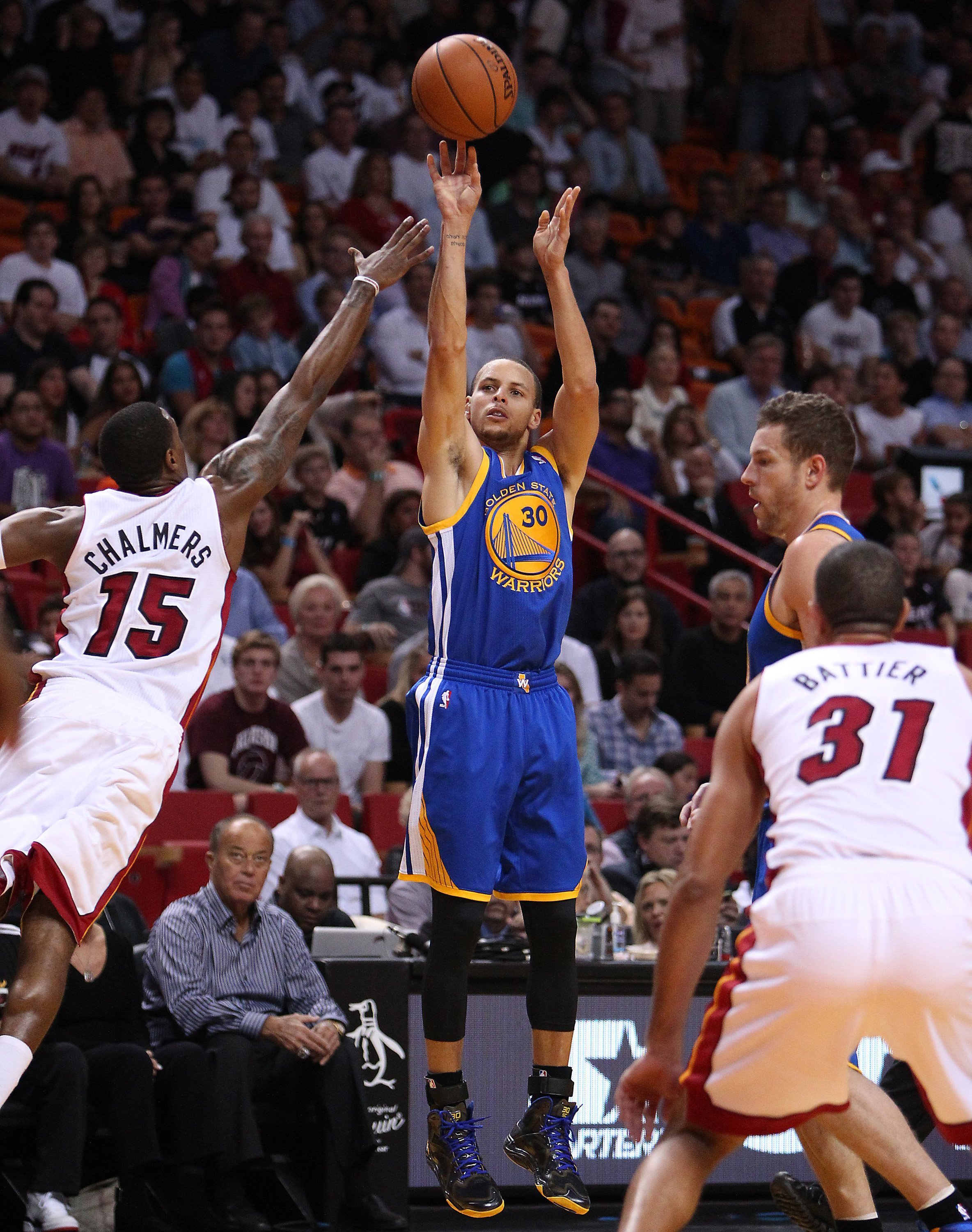 Golden State Warriors guard Stephen Curry shoots over Miami Heat guard Mario Chalmers during the first quarter at AmericanAirlines Arena in Miami on Thursday, Jan. 2, 2014. (El Nuevo Herald—MCT/Getty Images)