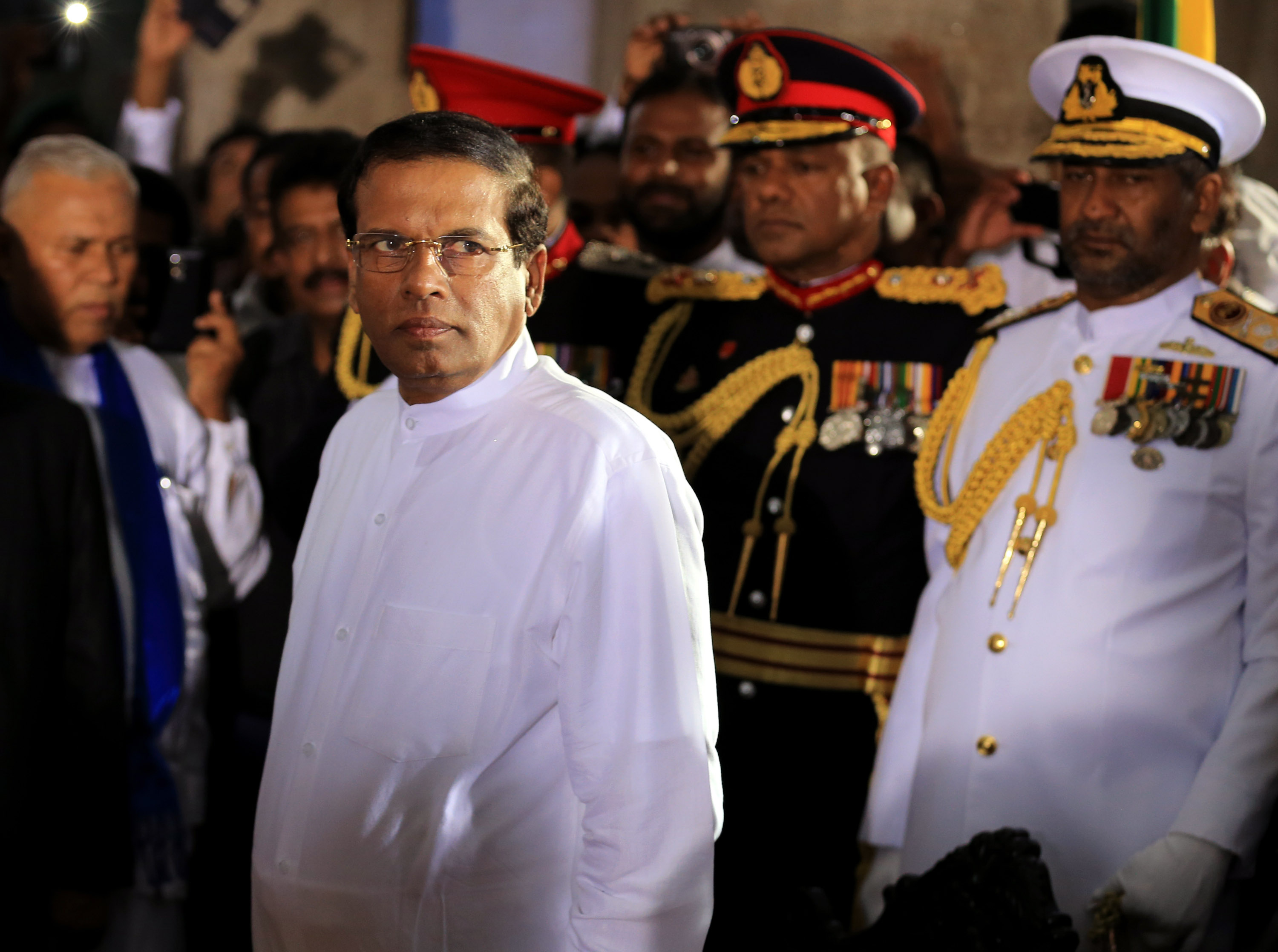 Sri Lanka's newly elected president Maithripala Sirisena (C) prepares to take oath as he is sworn in at Independence Square in Colombo on January 9, 2015 in Colombo, Sri Lanka. (Buddhika Weerasinghe—Getty Images)