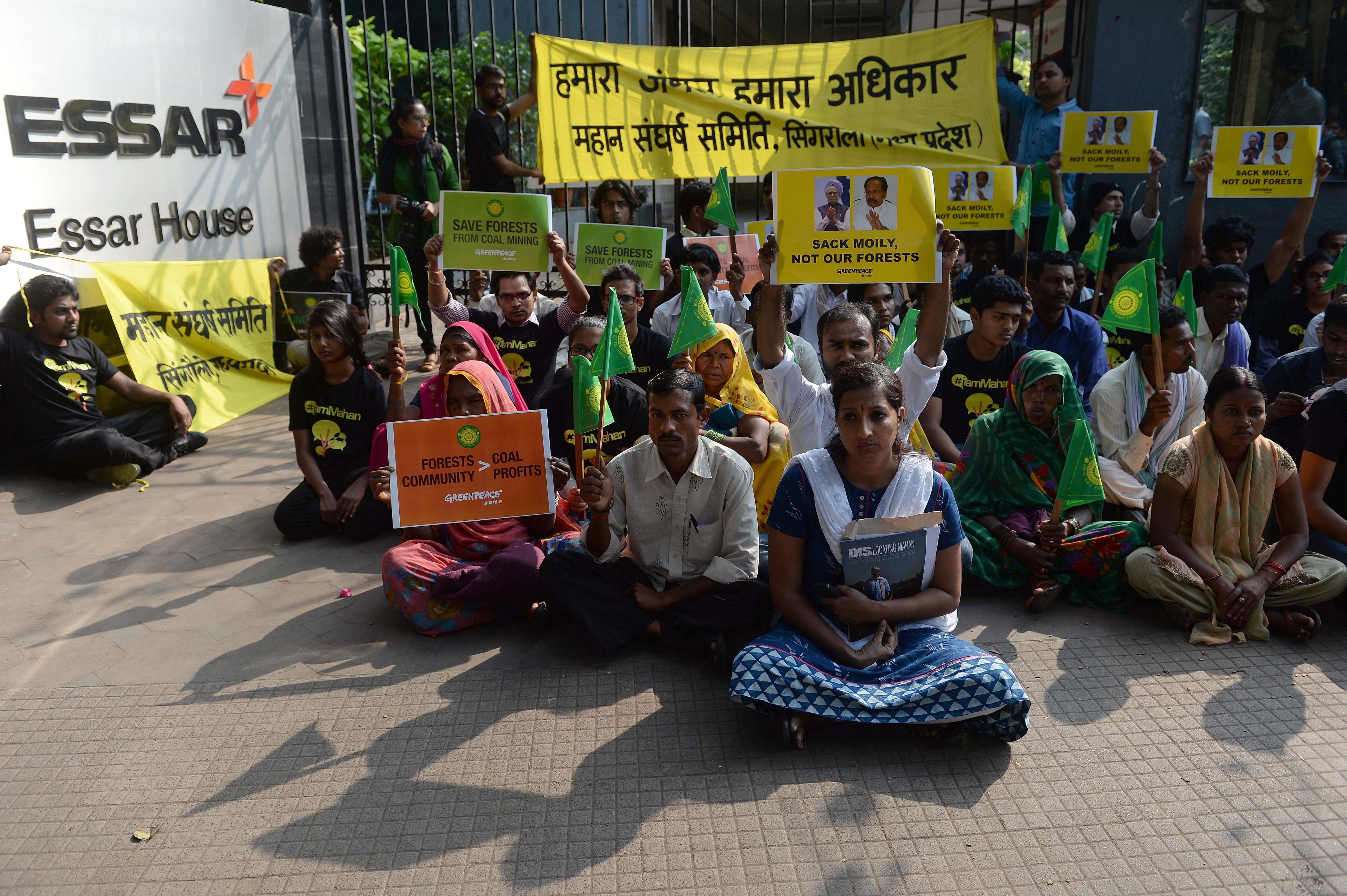 Activists from the environmental group Greenpeace and local farmers from Madhya Pradesh state sit outside the headquarters of India's Essar Group during a protest in Mumbai on Jan. 22, 2014 (Punit Paranjpe—AFP/Getty Images)
