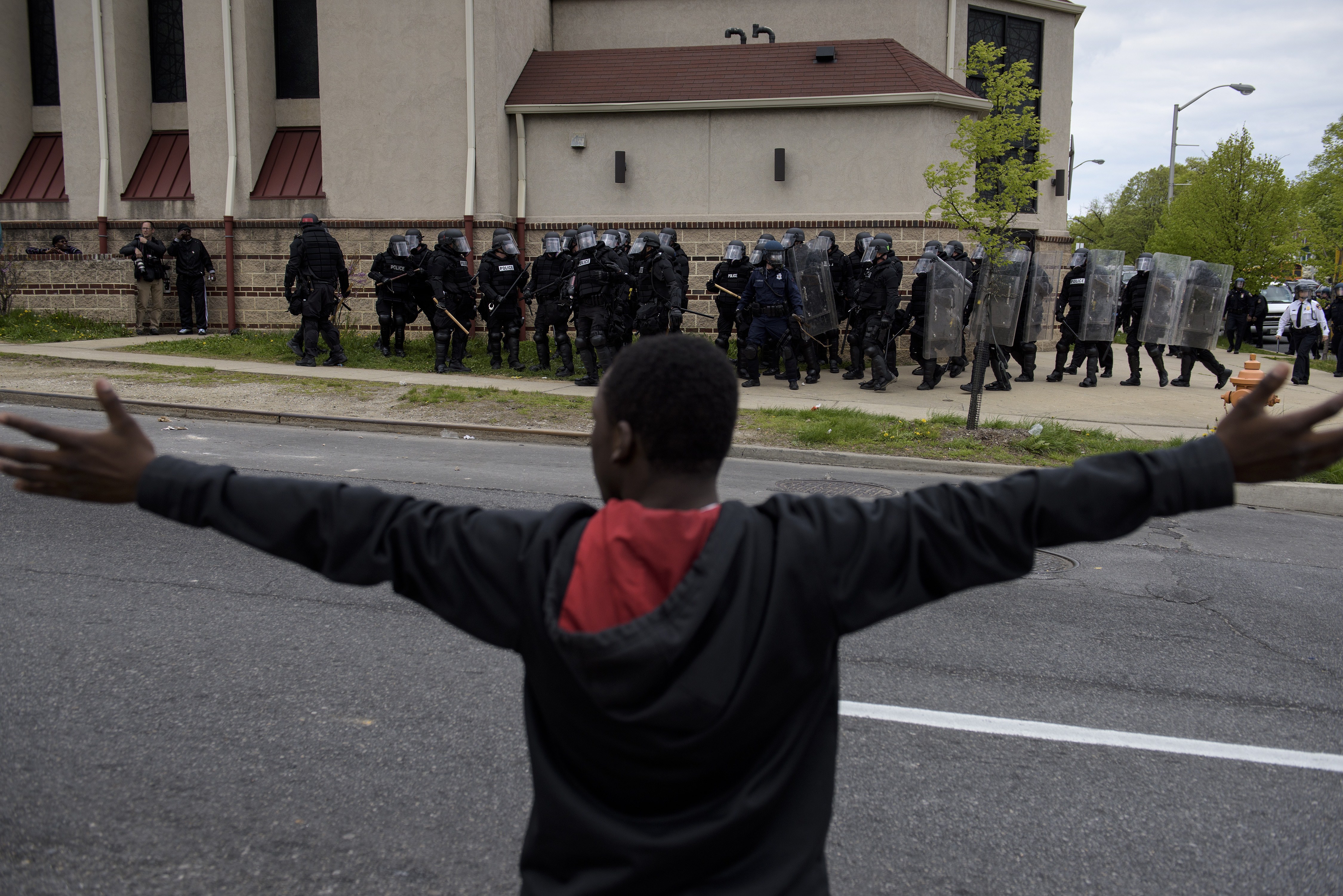 Baltimore police officers form a line in front of protesters in the streets near Mondawmin Mall April 27, 2015 in Baltimore, Maryland. (BRENDAN SMIALOWSKI&mdash;AFP/Getty Images)