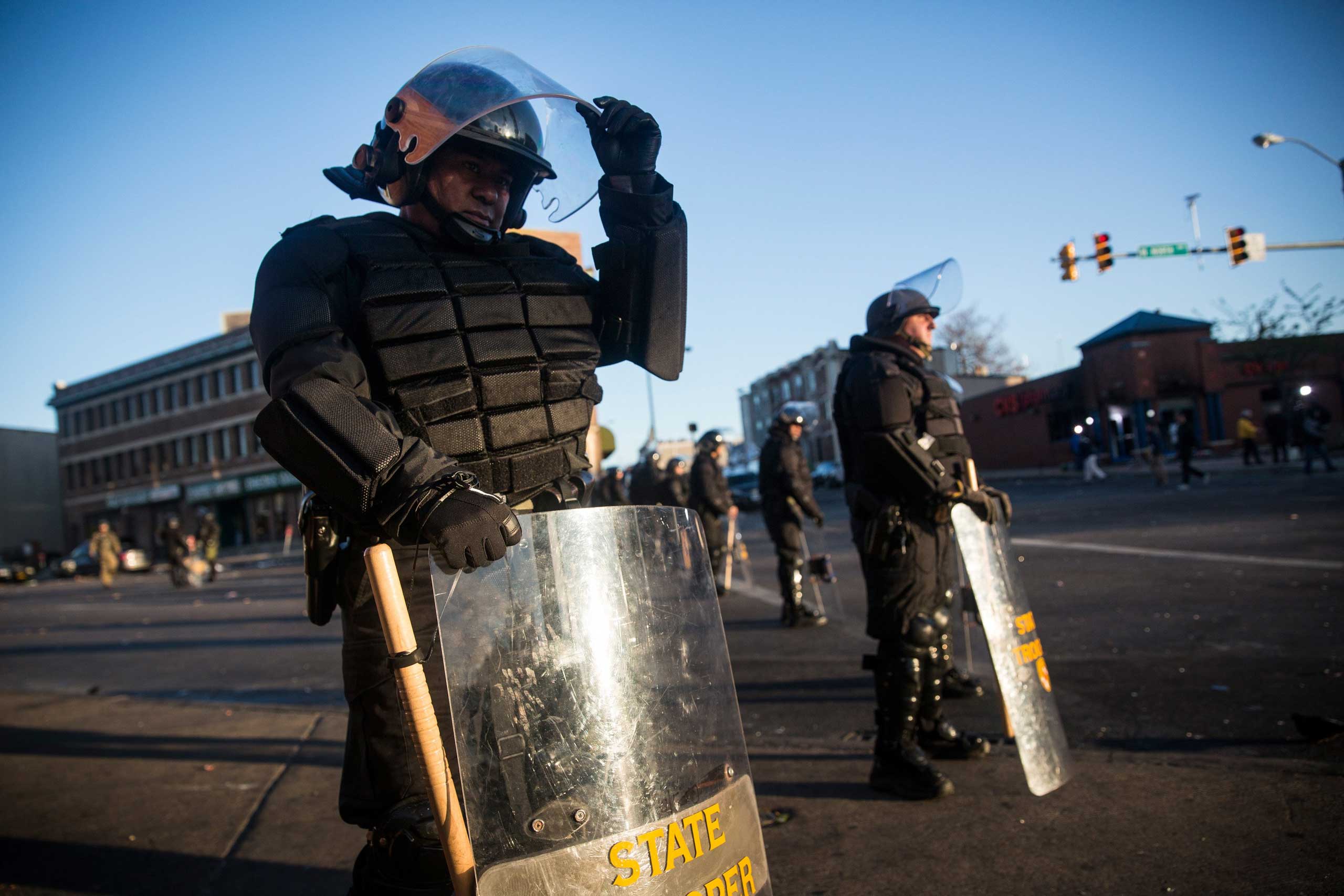 Maryland state troopers stand guard near a CVS pharmacy that was burned during riots in Baltimore, April 28, 2015.