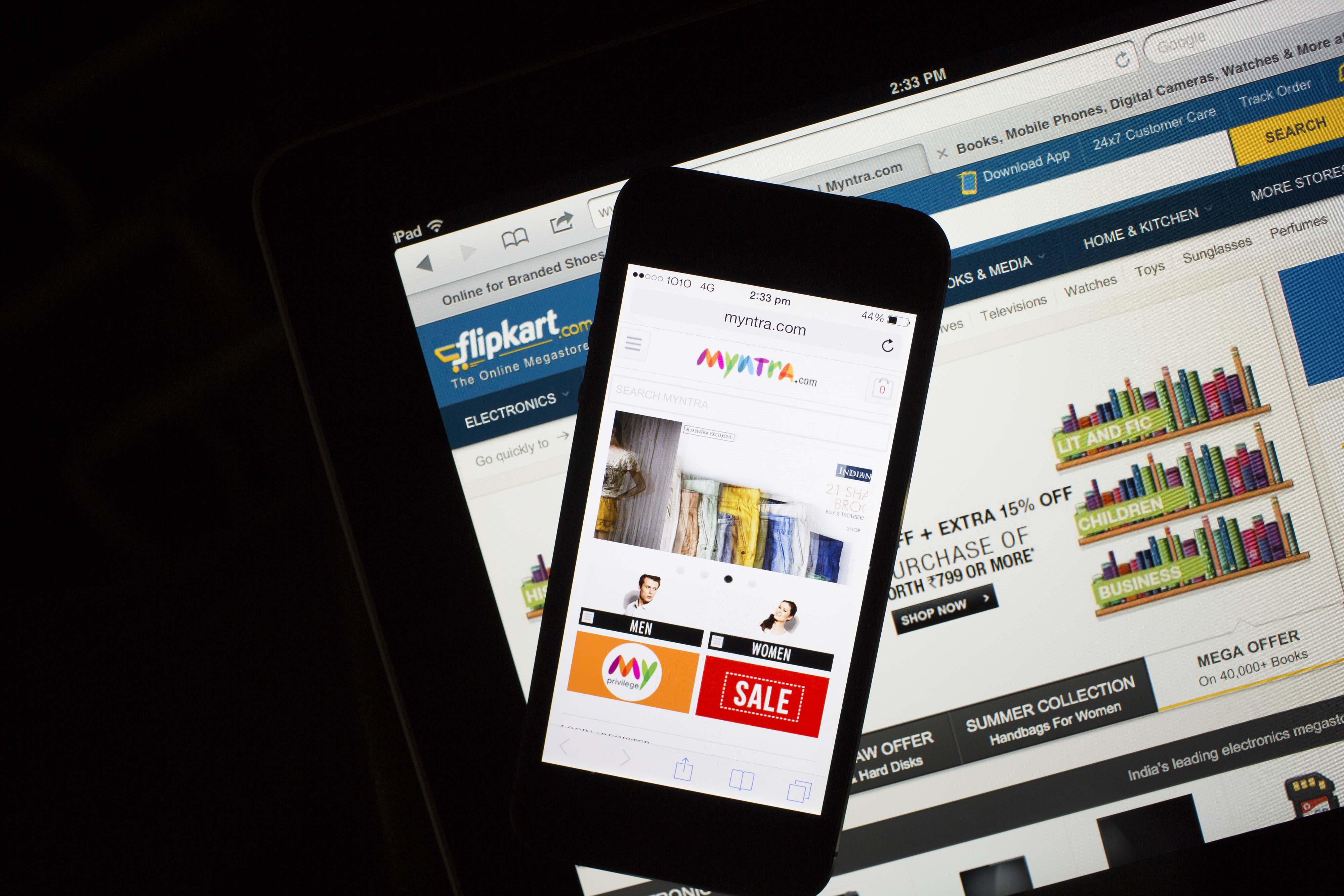 The websites for Flipkart, bottom, and Myntra.com are displayed on an Apple Inc. iPad and iPhone 5c respectively in an arranged photograph in Hong Kong, China, on Wednesday, May 21, 2014. (Brent Lewin—Bloomberg/Getty Images)