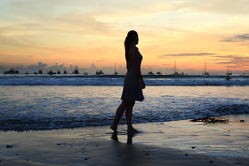 woman-standing-beach-silhouette