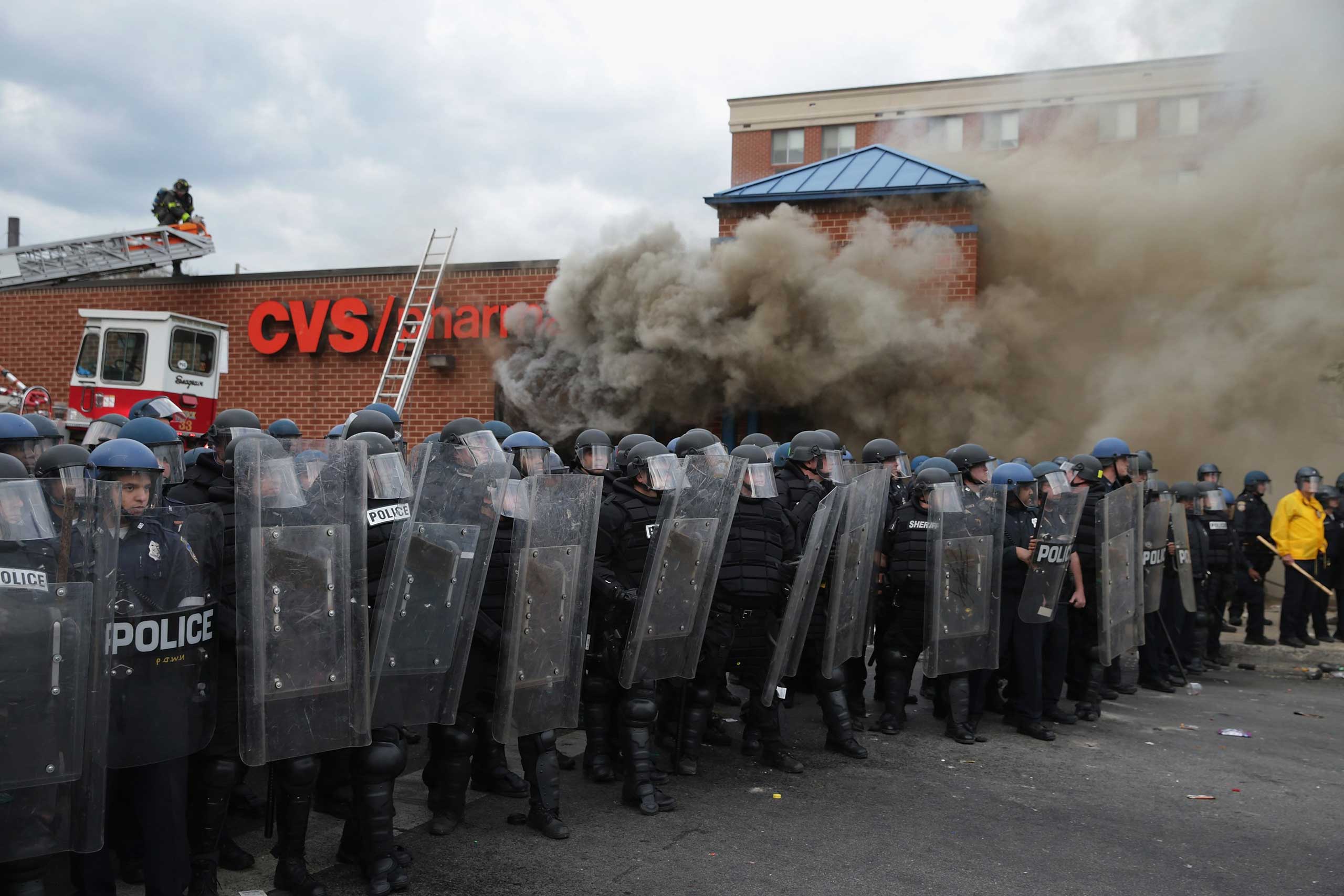 Baltimore Police form a perimeter around a CVS pharmacy that was looted and burned in Baltimore on April 27, 2015. (Chip Somodevilla—Getty Images)