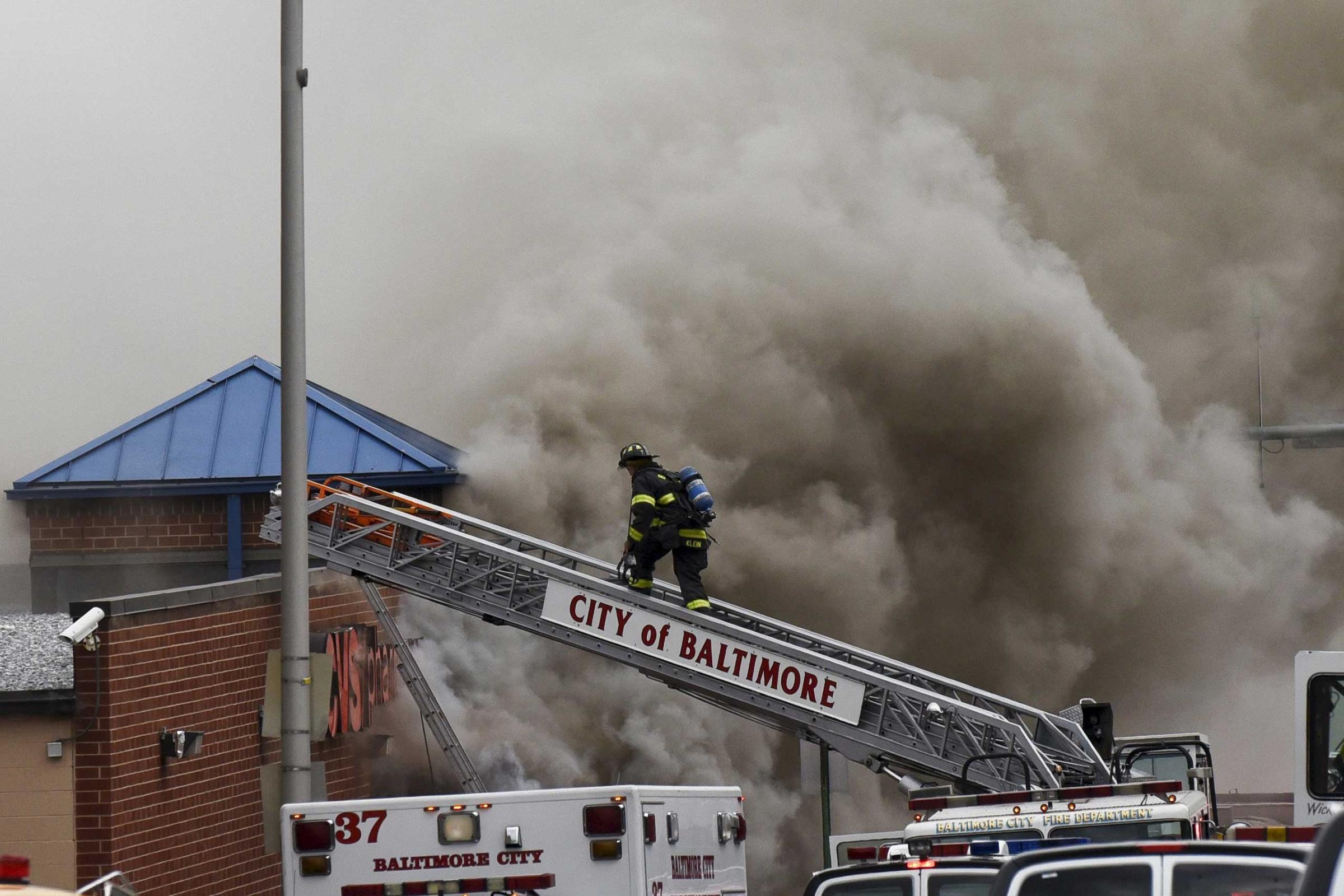Fire figthers respond to a fire at a CVS pharmacy in Baltimore on April 27, 2015.