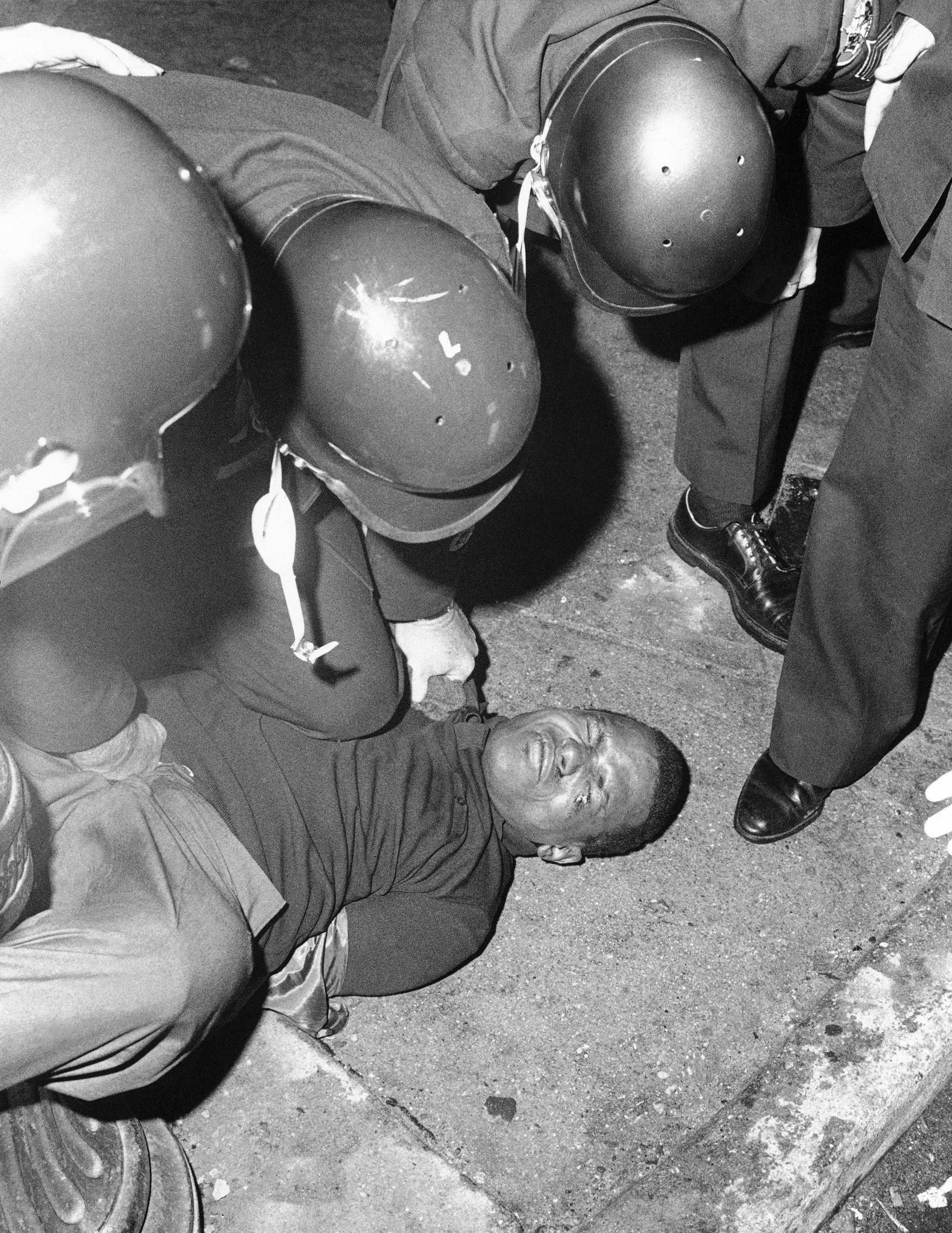 Baltimore City police pin down a curfew breaker in Baltimore on April 9, 1968.