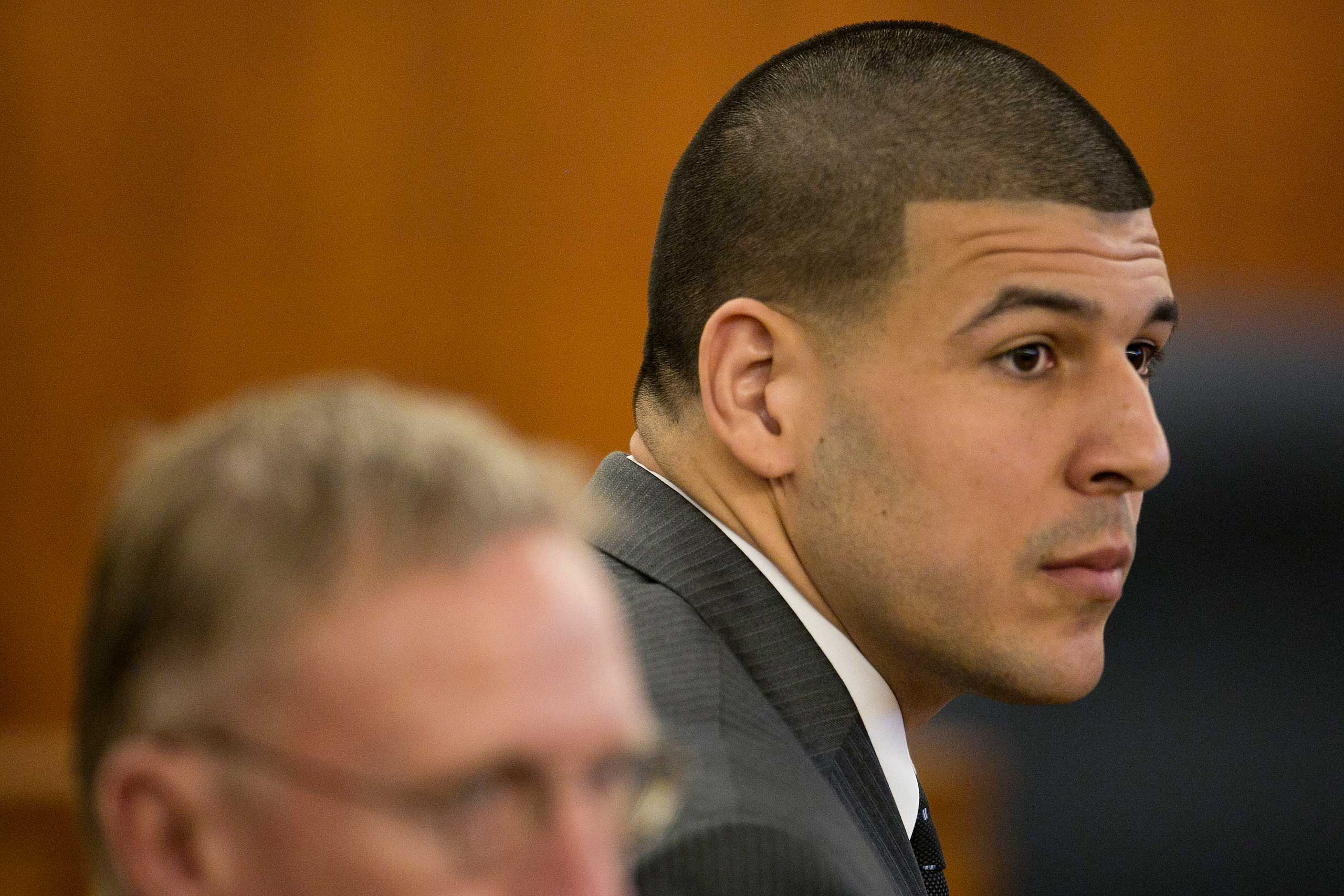 Former New England Patriots NFL football player Aaron Hernandez listens during his murder trial at the Bristol County Superior Court in Fall River, Mass., April 15, 2015. (Dominick Reuter—AP)