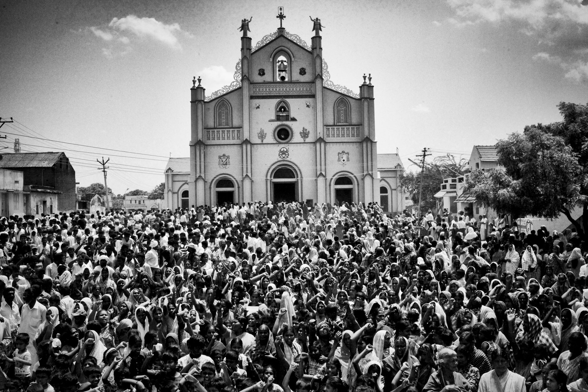 Villagers from Koothankuli, prevented from going to Idinthakarai by the imposition of a curfew, gather in front of the church and shout anti-government slogans.