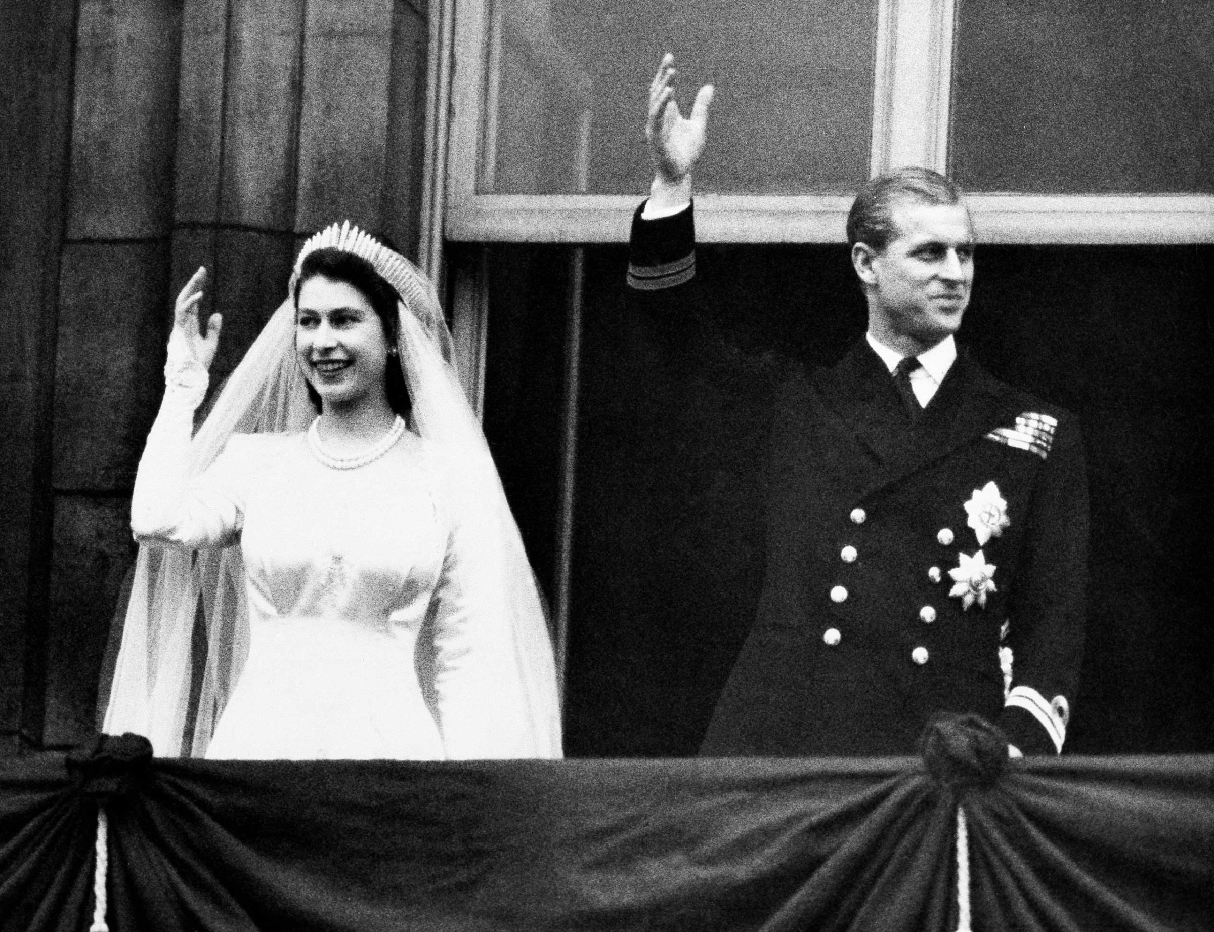 Princess Elizabeth and Prince Philip, Duke of Edinburgh wave to the crowds from the balcony of Buckingham Palace in London on their wedding day. Nov. 20,1947.