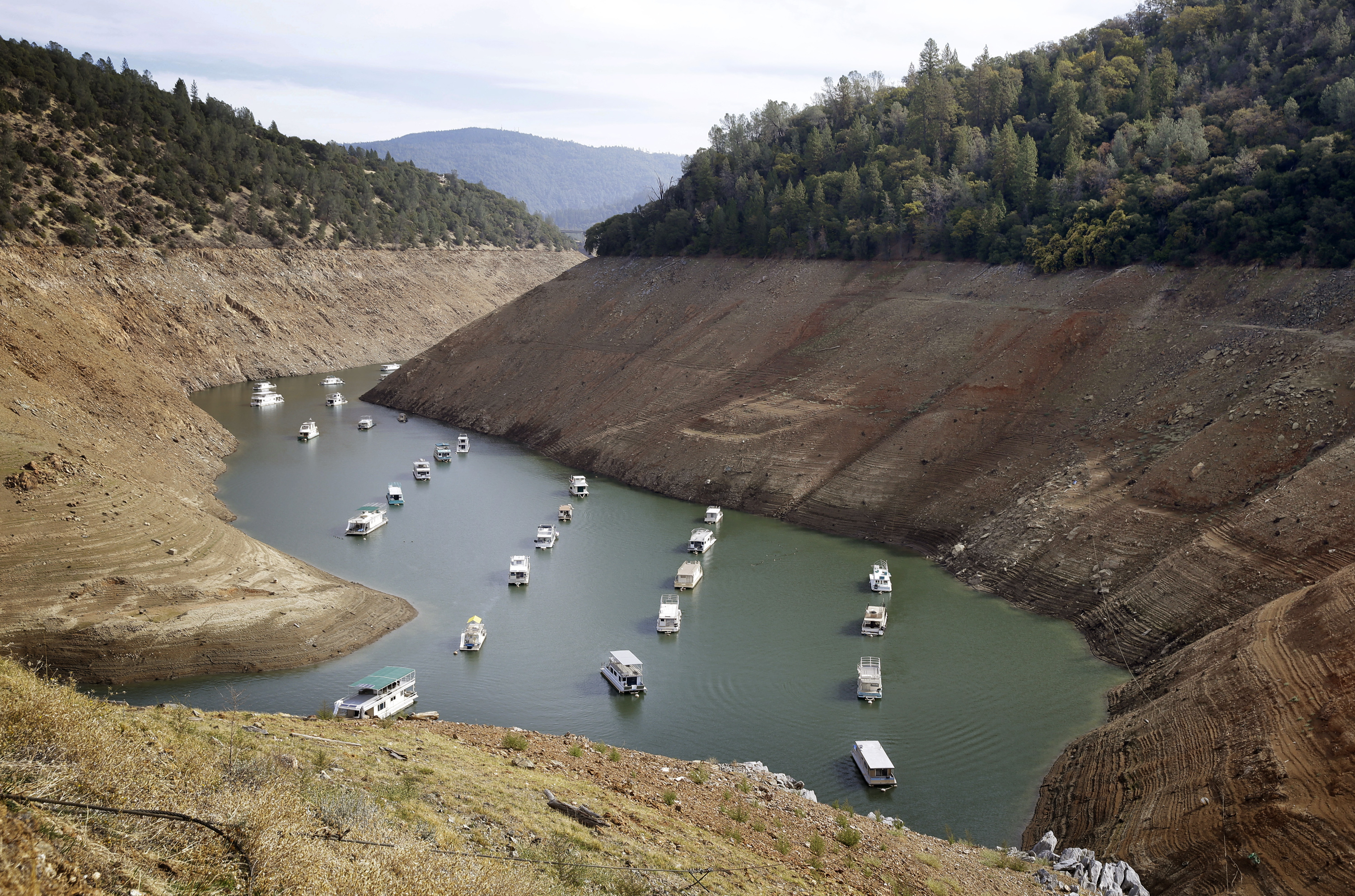 Houseboats float in the drought-lowered waters of Oroville Lake near Oroville, Calif., Oct. 30, 2014. Gov. Jerry Brown on April 1, 2015, ordered sweeping and unprecedented measures to save water in California. (Rich Pedroncelli—AP)