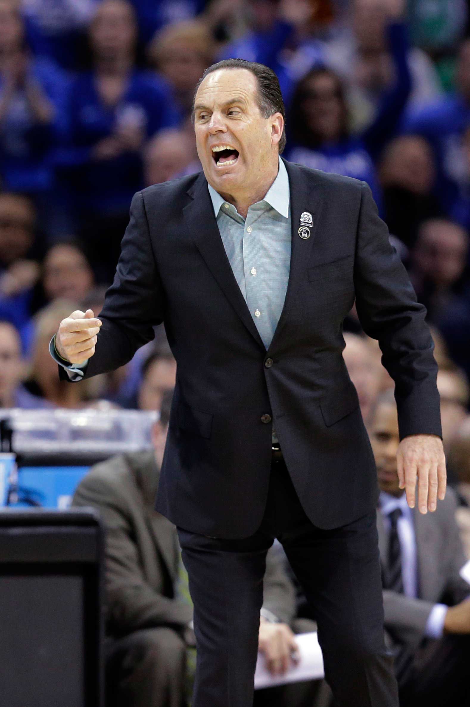 Notre Dame coach Mike Brey yells to his team during the first half of a college basketball game against Kentucky in the NCAA men's tournament regional finals, in Cleveland, March 28, 2015.