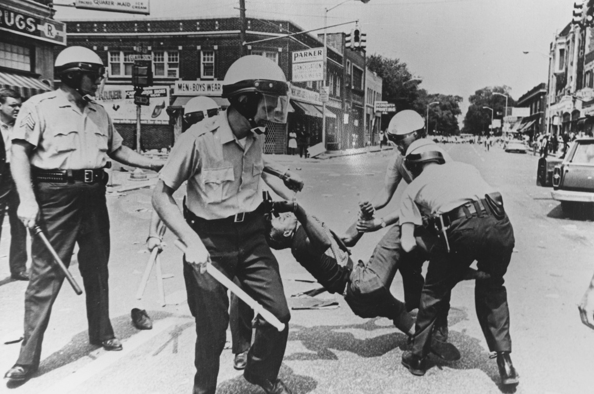 A man carried away by police during riots, Baltimore, Maryland, 1968. (Picasa / Getty Images)