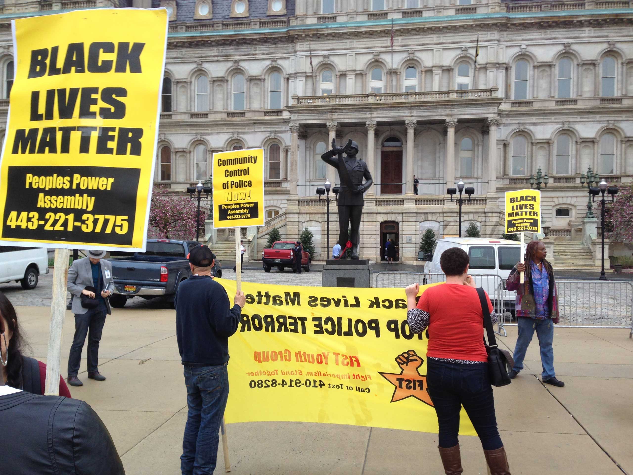 Demonstrators protest the death of Freddie Gray outside Baltimore City Hall on April 20, 2015. (David Dishneau—AP)